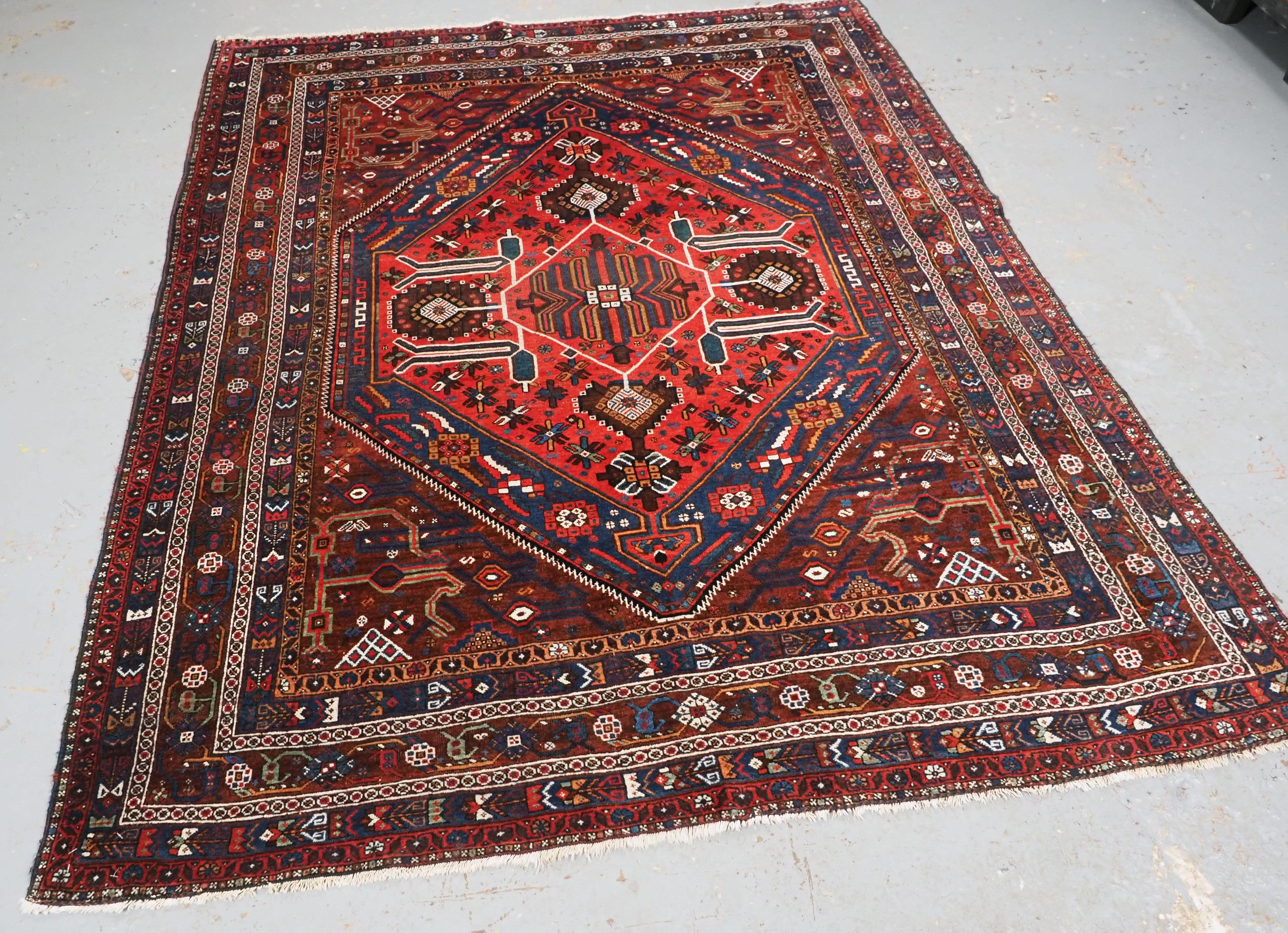 
Size: 6ft 8in x 5ft 3in (202 x 159cm).

Antique  Khamseh Rug with large medallion design.

Circa 1900.

A tribal rug of the classic Khamseh design with a large central medallion containing floral rosettes. The rug has a classic Khamseh border