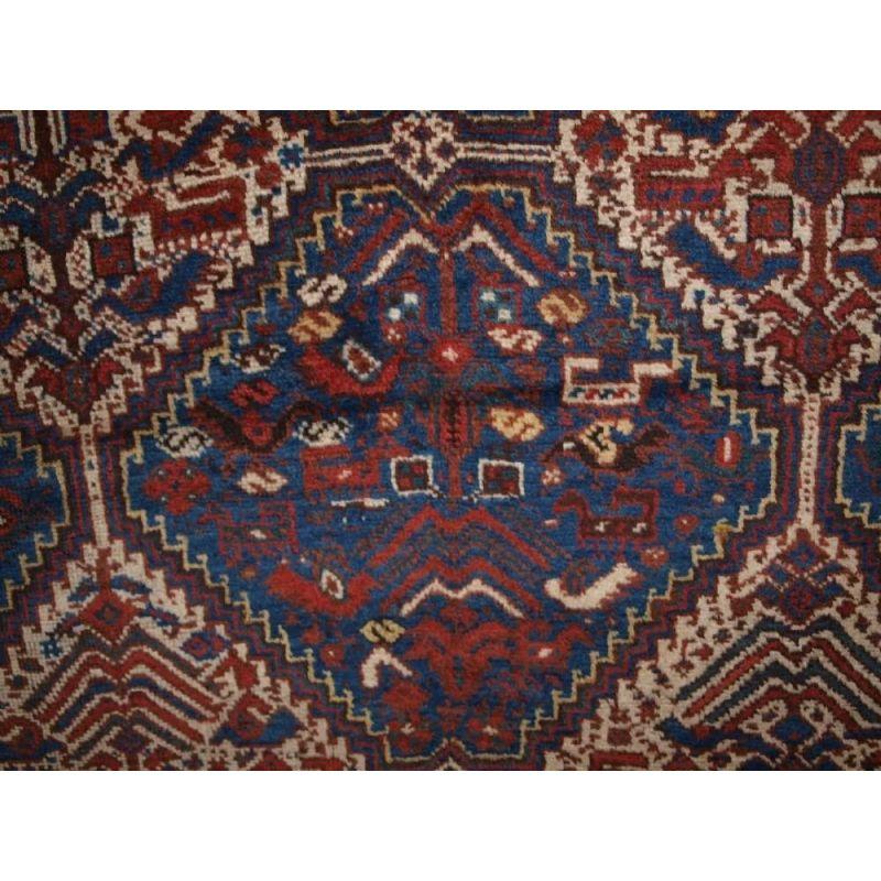 A classic example of a Khamseh ‘bird’ rug. Six ivory linked medallions on an indigo blue field filled with birds and animals. A superb border frames the rug. The rug is of a very useful almost square shape.

The rug is in excellent condition with