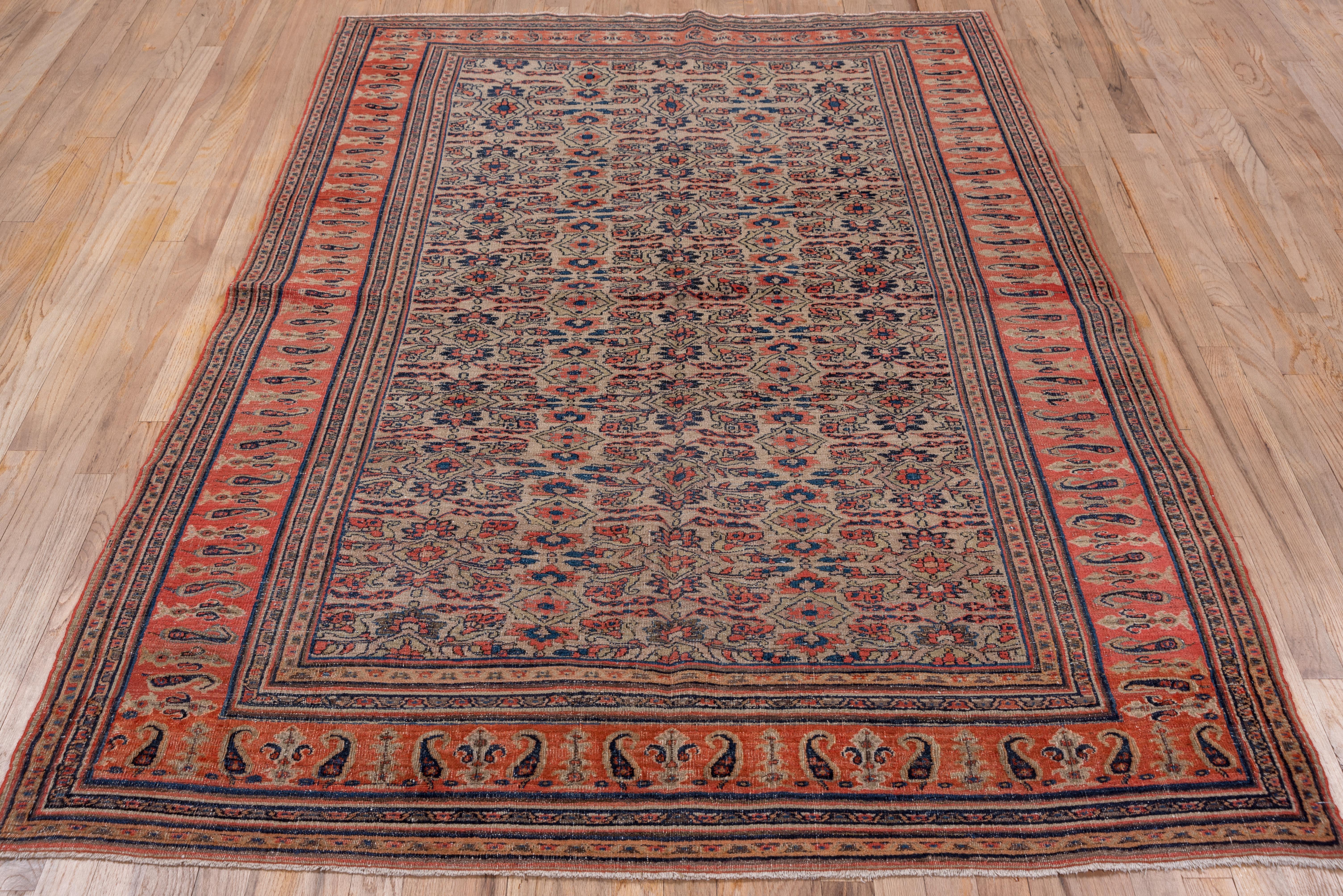 This NE Persian town scatter features an oatmeal field with a variant on the popular Herati design. Here the usual 'fish' leaves have been flattened and minimized. The orange-red main border shows slender, standing botehs and lesser botehs paired