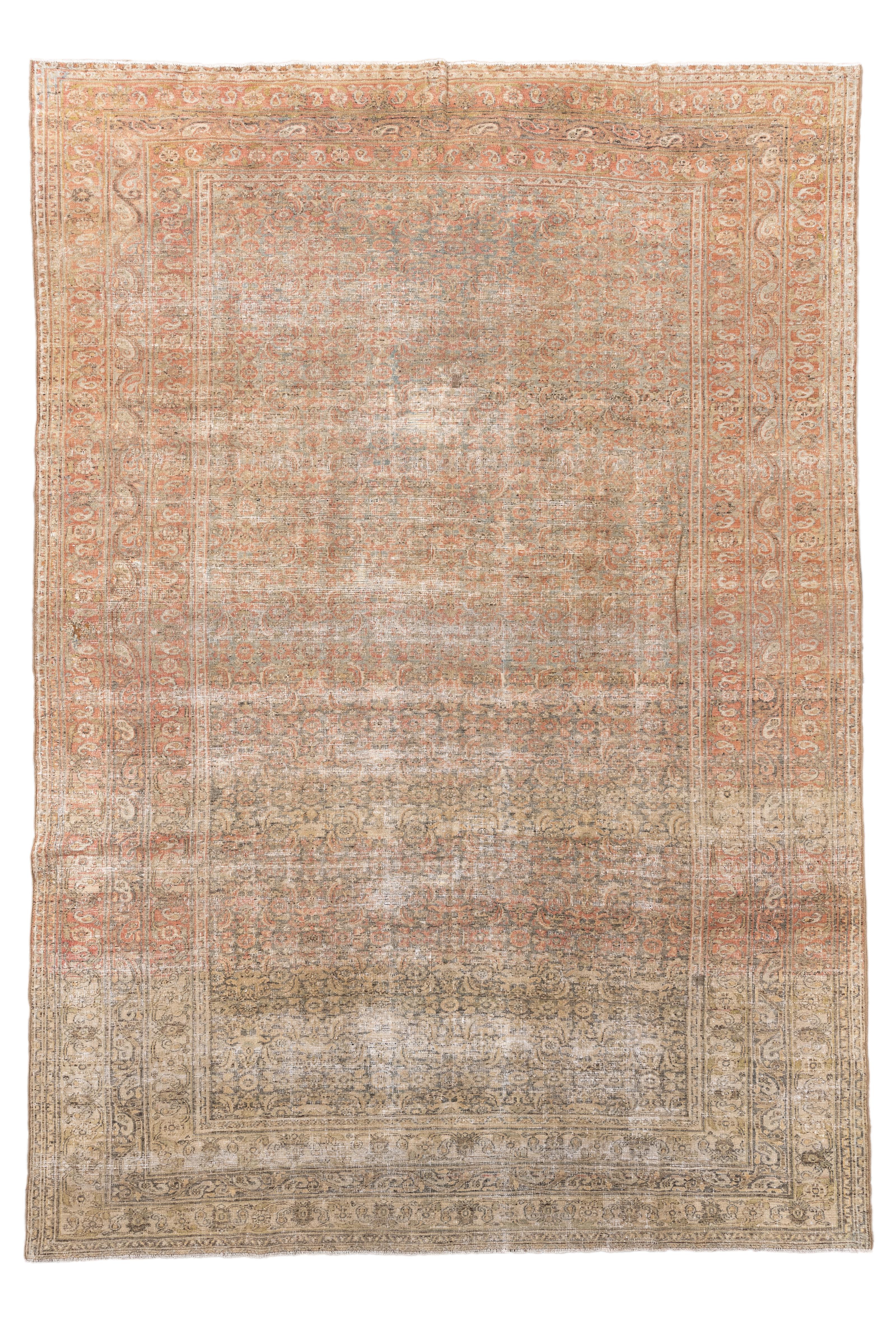 This antique Khorassan rug boasts a softly faded palette of sand, rose, and pale blue that whispers the story of its age and elegance. Woven around 1900, the rug features a dense allover floral pattern that has gently dissolved into a painterly,