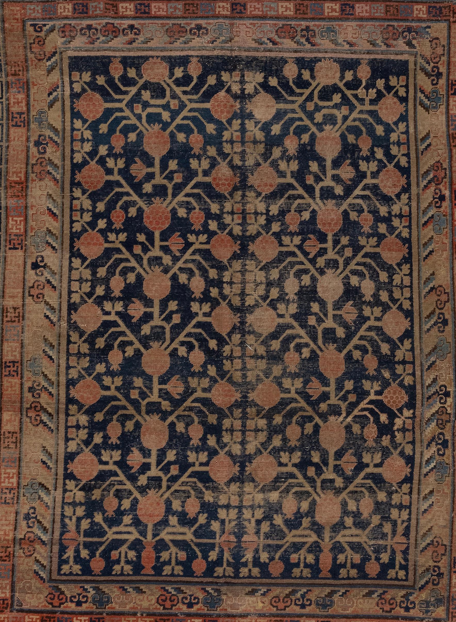 Late 19th century East Turkistan Khotan rug with pomegranate design.