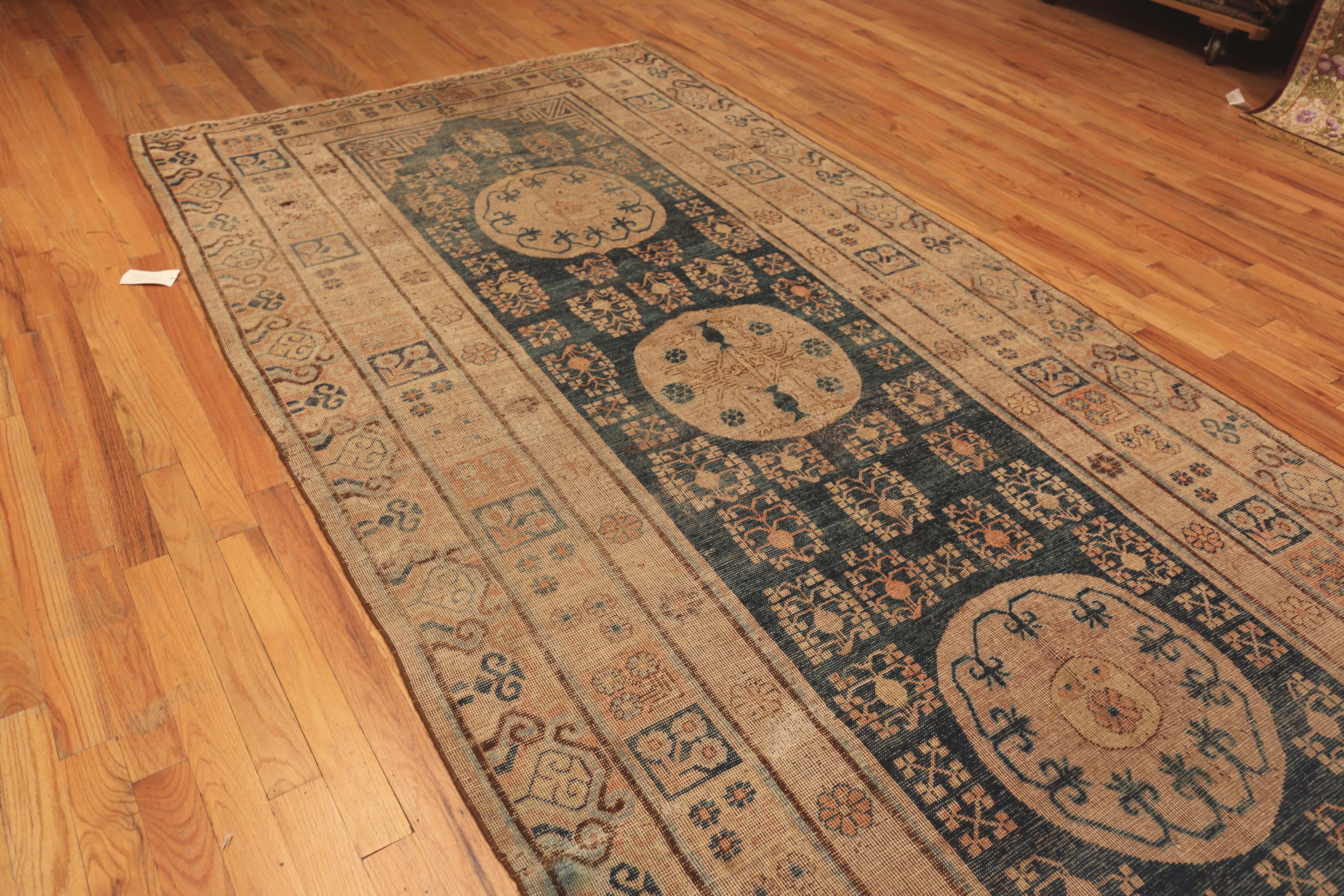 Antique Khotan East Turkestan Rug, Country of Origin / Rug Type: East Turkestan Rugs, Circa date: 1900. Size: 6 ft 6 in x 13 ft 9 in (1.98 m x 4.19 m)
