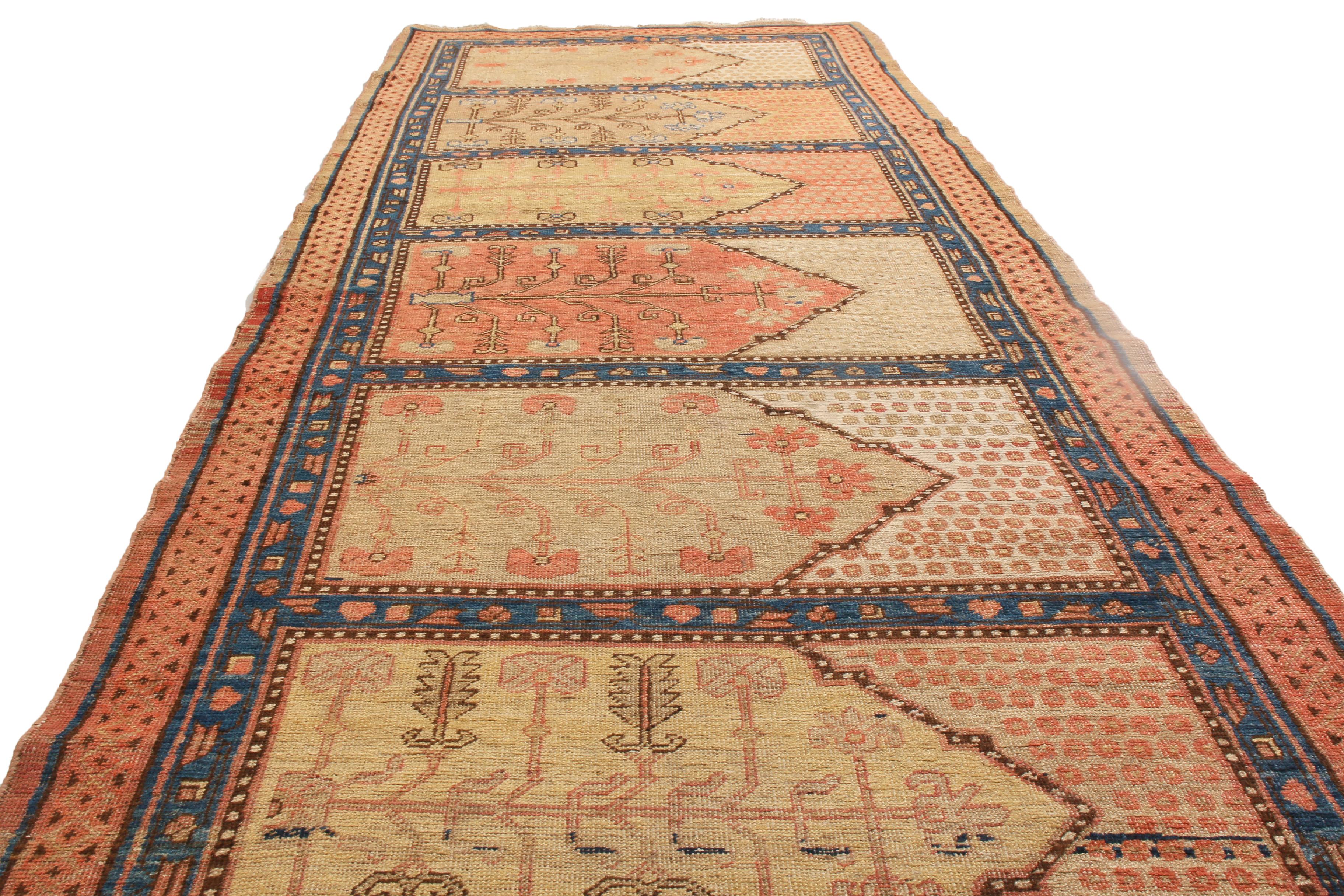 Hand knotted in high quality wool and originating from East Turkestan in 1920, this antique Khotan runner features a notably unique and subversive field design with horizontal medallion patterns. Uncommon to transitional Khotan designs typically