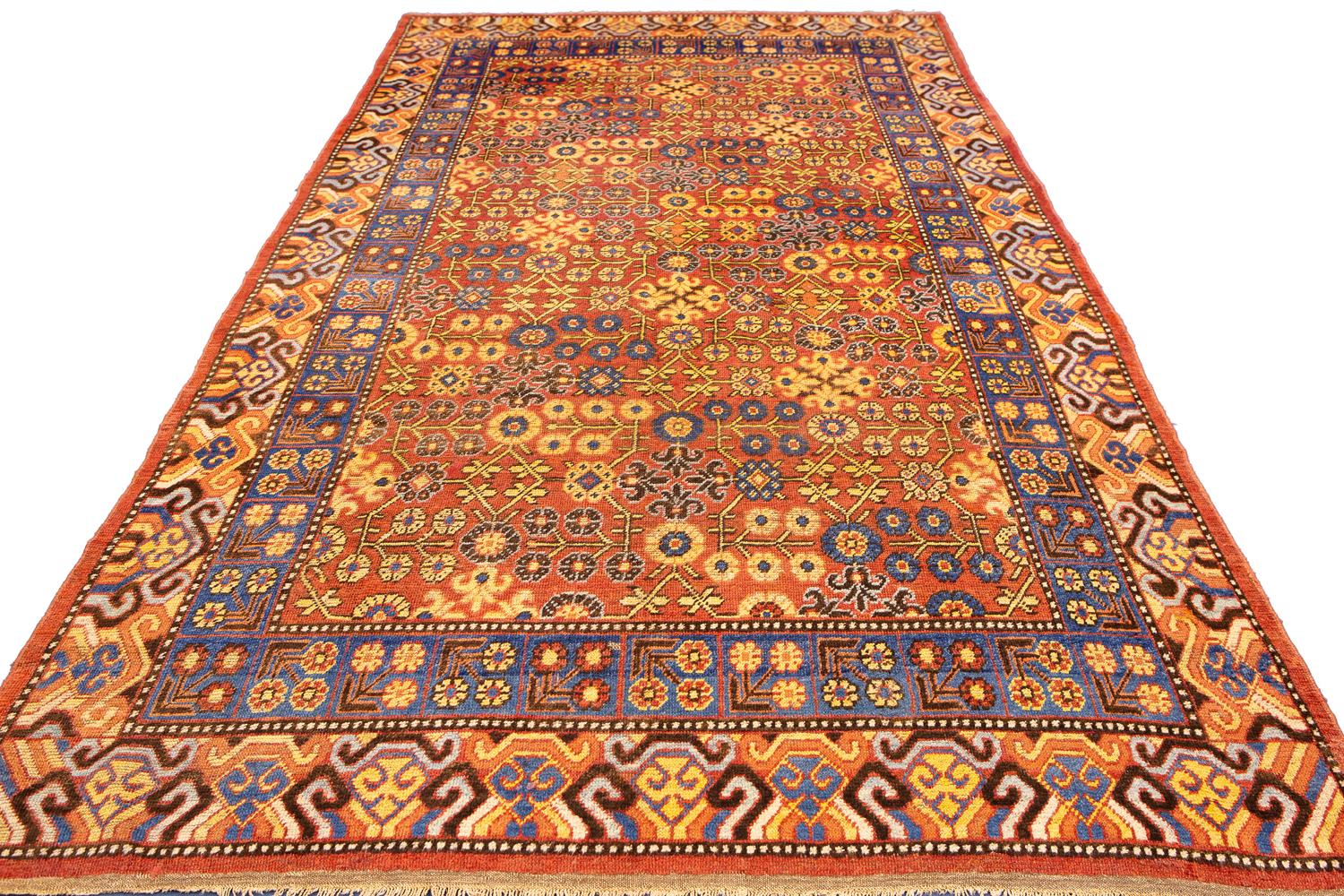 This antique Khotan rug is a beautiful piece that would add an air of elegance to any room. The colors are bold and eye-catching, and the rug is made from high-quality materials. It would be perfect for a home with a traditional style or for anyone