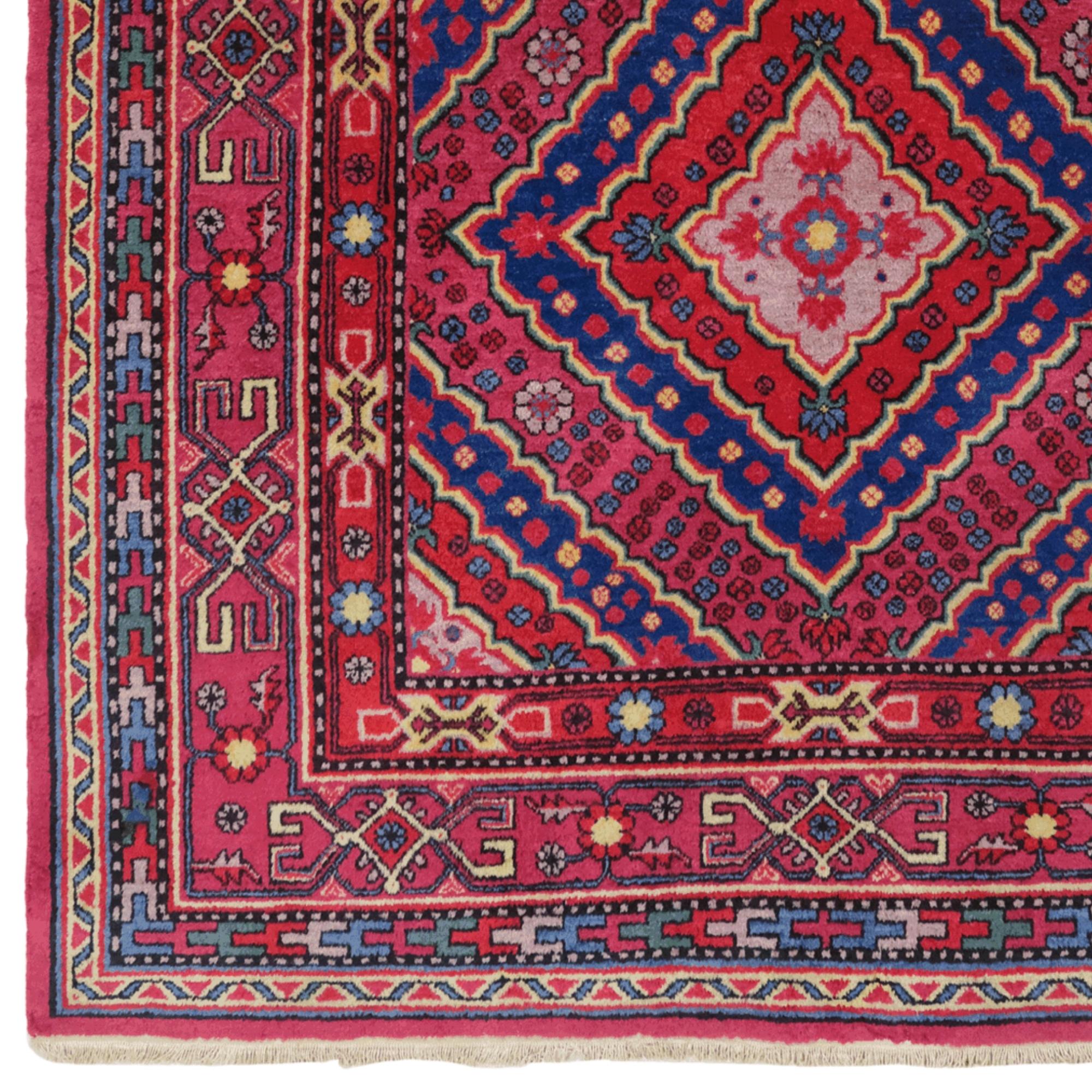 Antique Khotan Rug - 19th Century Central Asia Rug

This unique kotan carpet is a rare work that brings the tradition of 19th century craftsmanship to the present day. This magnificent carpet, dominated by vibrant red and blue tones, dazzles with