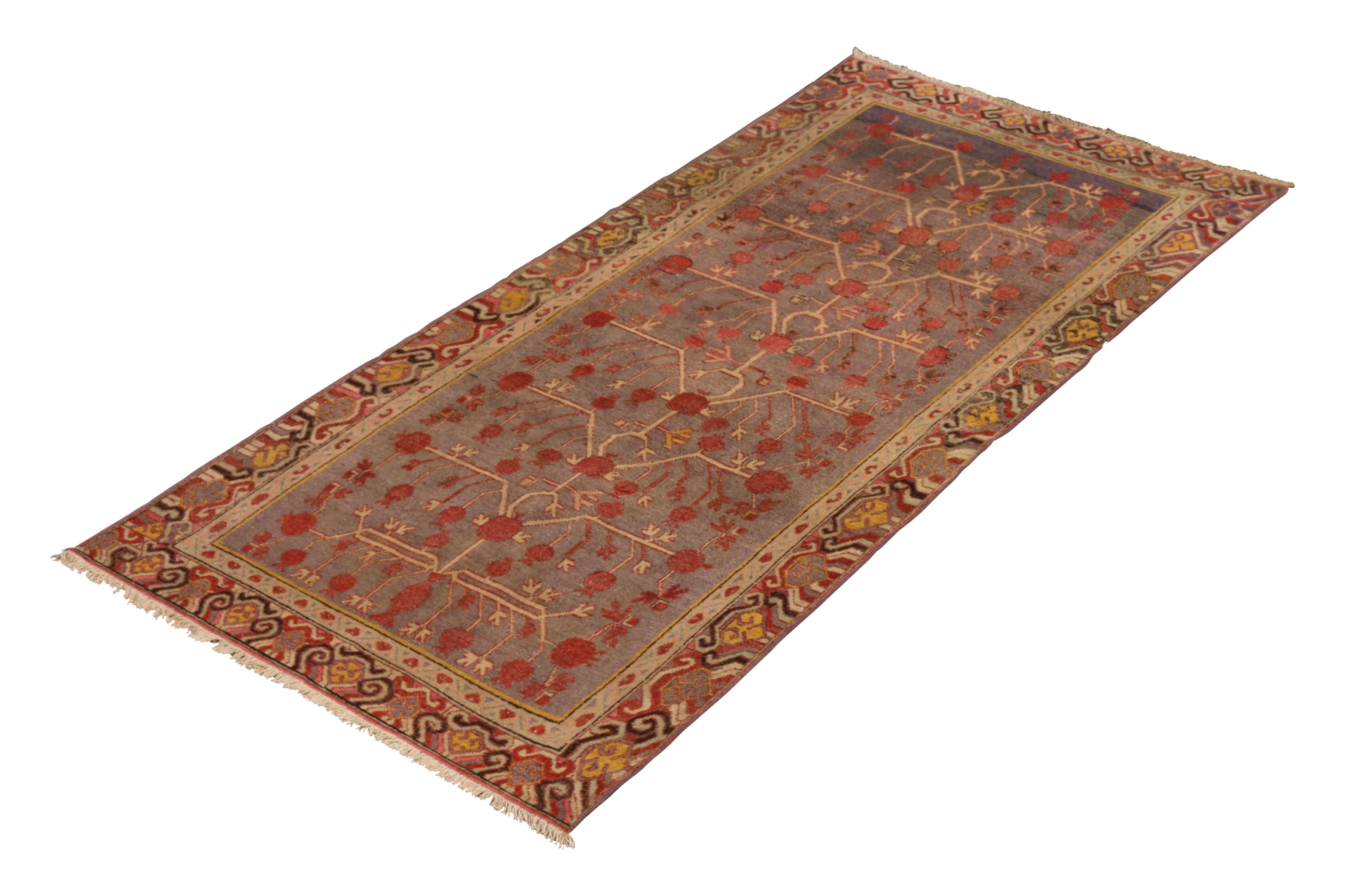 Hand knotted in wool originating from East Turkestan circa 1890-1900, this antique rug connotes a classic Khotan rug design with a classic approach to transitional colorway celebrated in this oriental rug family. Further enjoying the classic