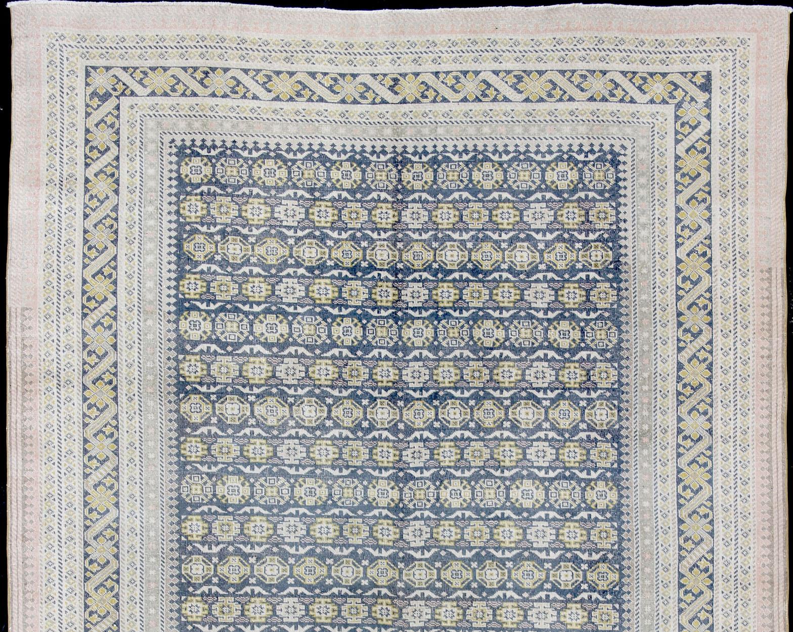 Alfombra antigua Khotan en tonos azules con acentos grises, l. rosas y amarillos Turco en venta