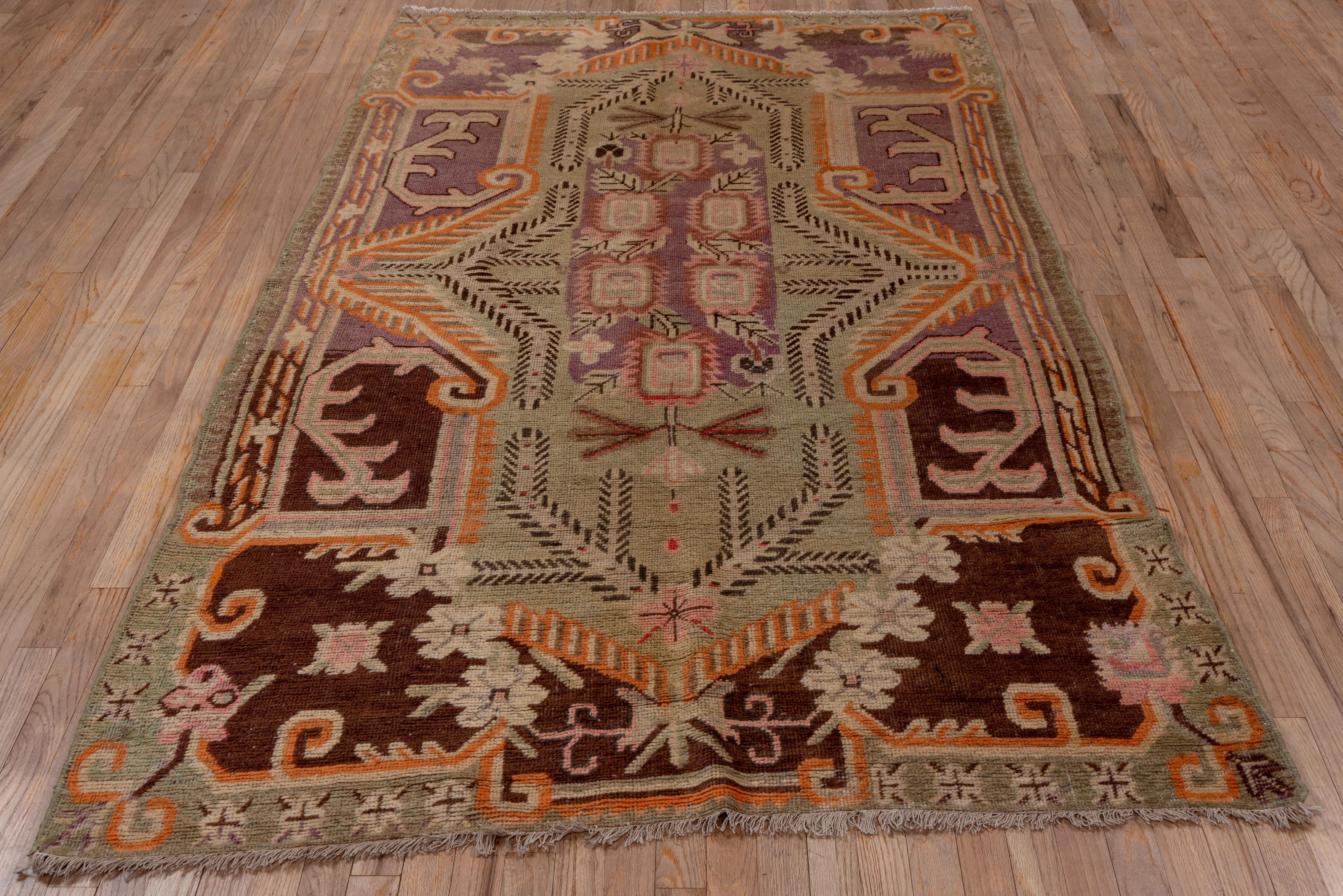 East Turkestani Antique Khotan Rug, Purple and Brown Outer Field, Green Borders, circa 1920s For Sale