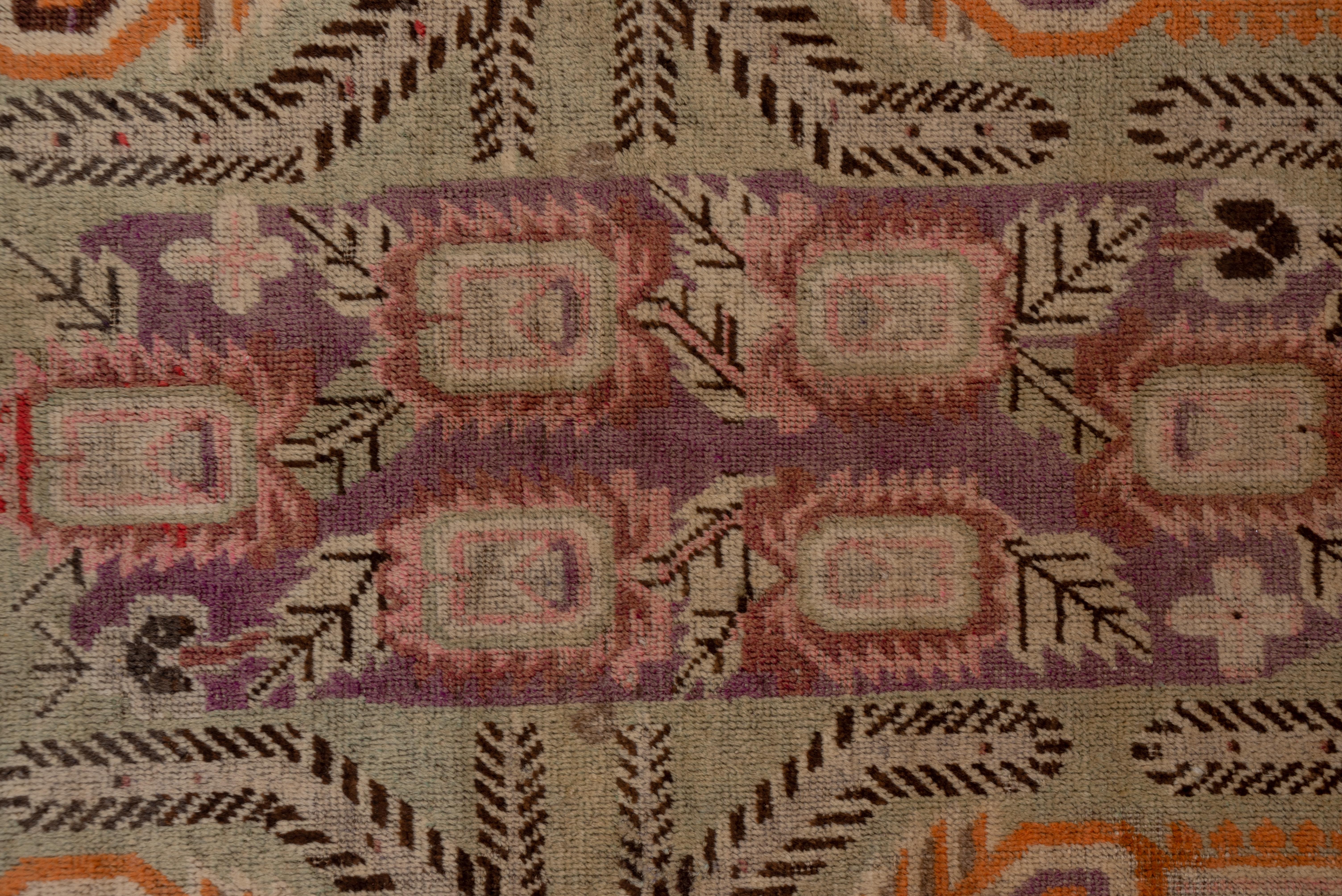 Hand-Knotted Antique Khotan Rug, Purple and Brown Outer Field, Green Borders, circa 1920s