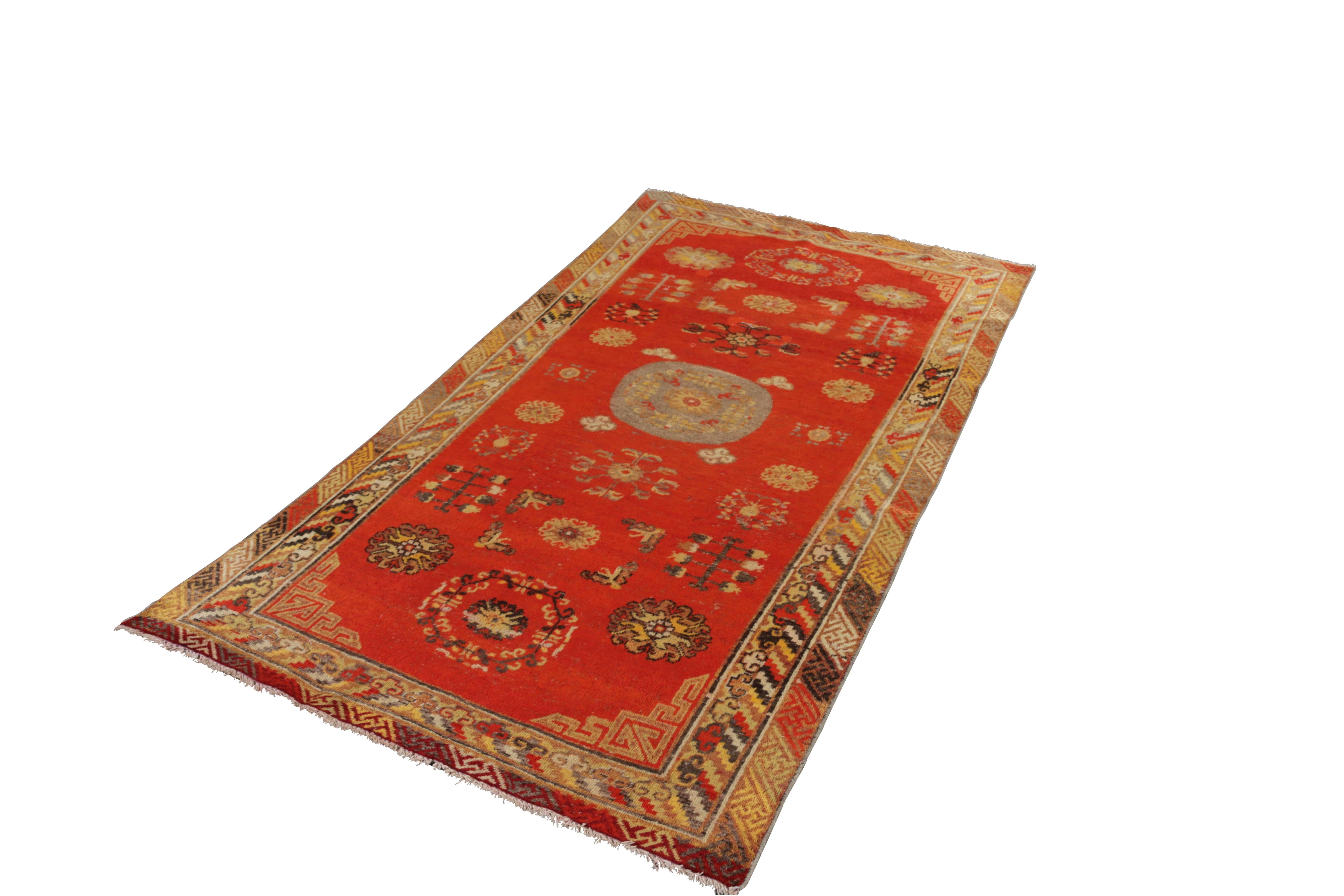 Hand knotted in wool originating from East Turkestan circa 1890-1900, this antique rug connotes a Classic Khotan rug design with a Classic approach to transitional colorway celebrated in this Oriental rug family. Favoring the cloudband pattern in