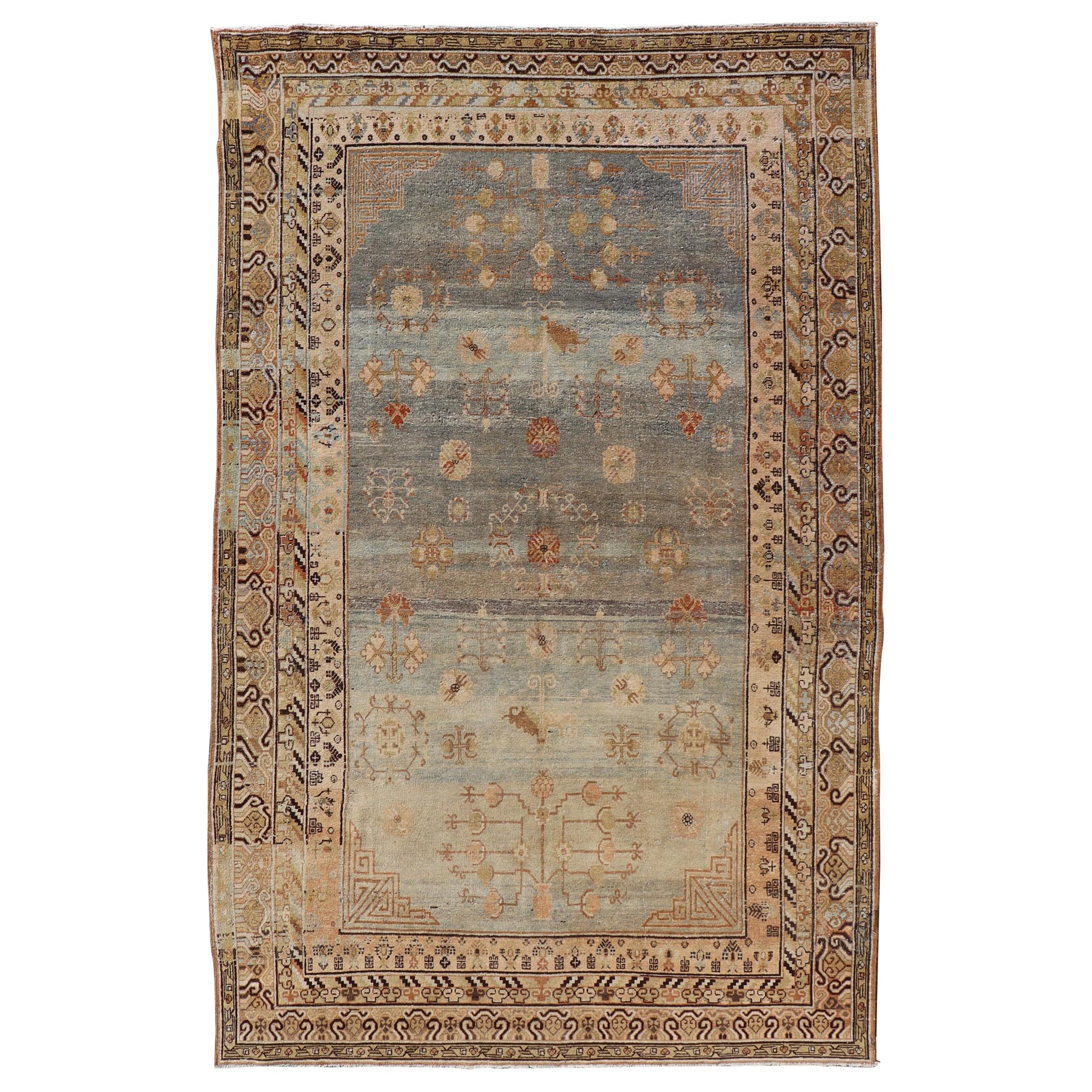 Antique Khotan Rug With Soft Blue Field and Symbolic Motif Design in Tan's