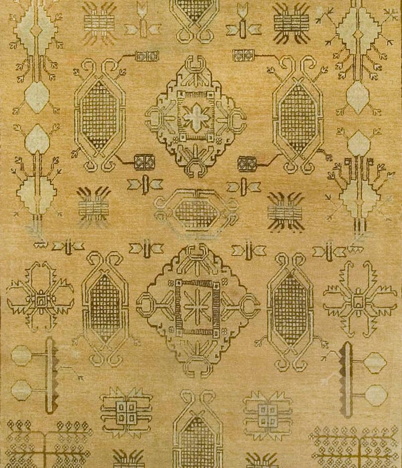 Antique Khotan Samarkand Gallery size rug, circa 1910, 9'2 x 17'1. A variety of organic designs cover the central field on this antique Khotan rug from China. A wide border of diagonals floral patterns and organic shapes surrounds the rug and is