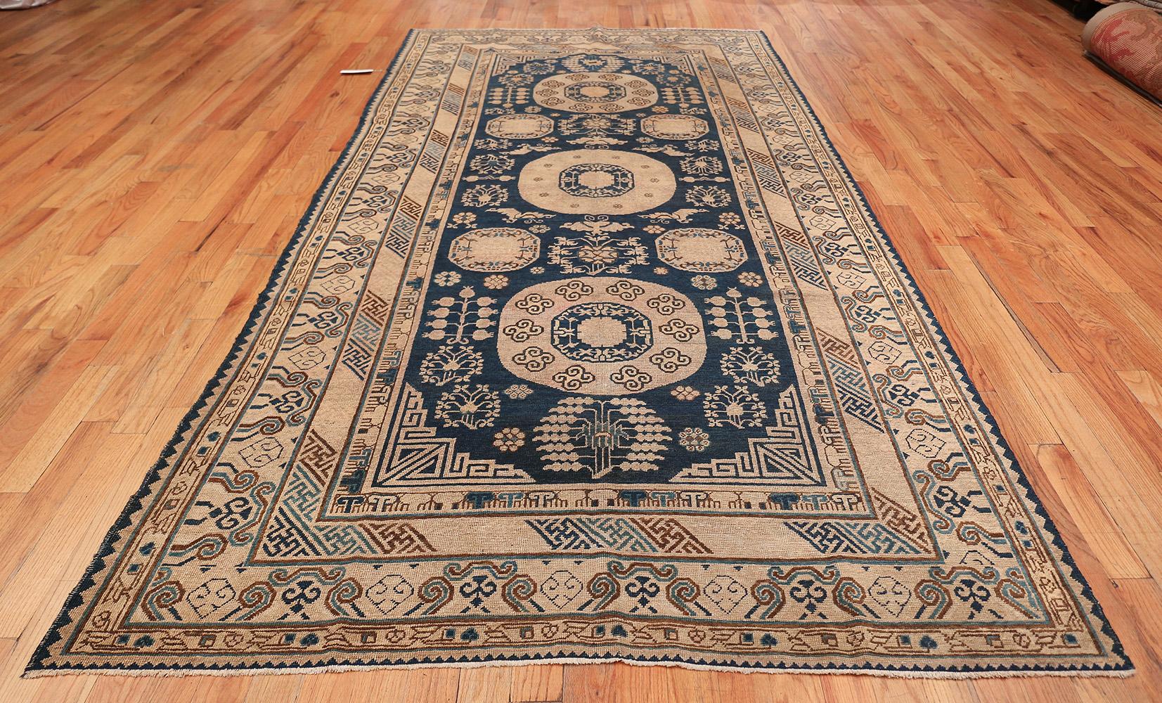 Antique Khotan, East Turkestan, circa late 19th century. Size: 6 ft x 12 ft 3 in (1.83 m x 3.73 m)

This breathtaking, earth-toned Khotan rug is the perfect touch for a nature-inspired or Oriental room design. Khotan is located in the Xinjiang
