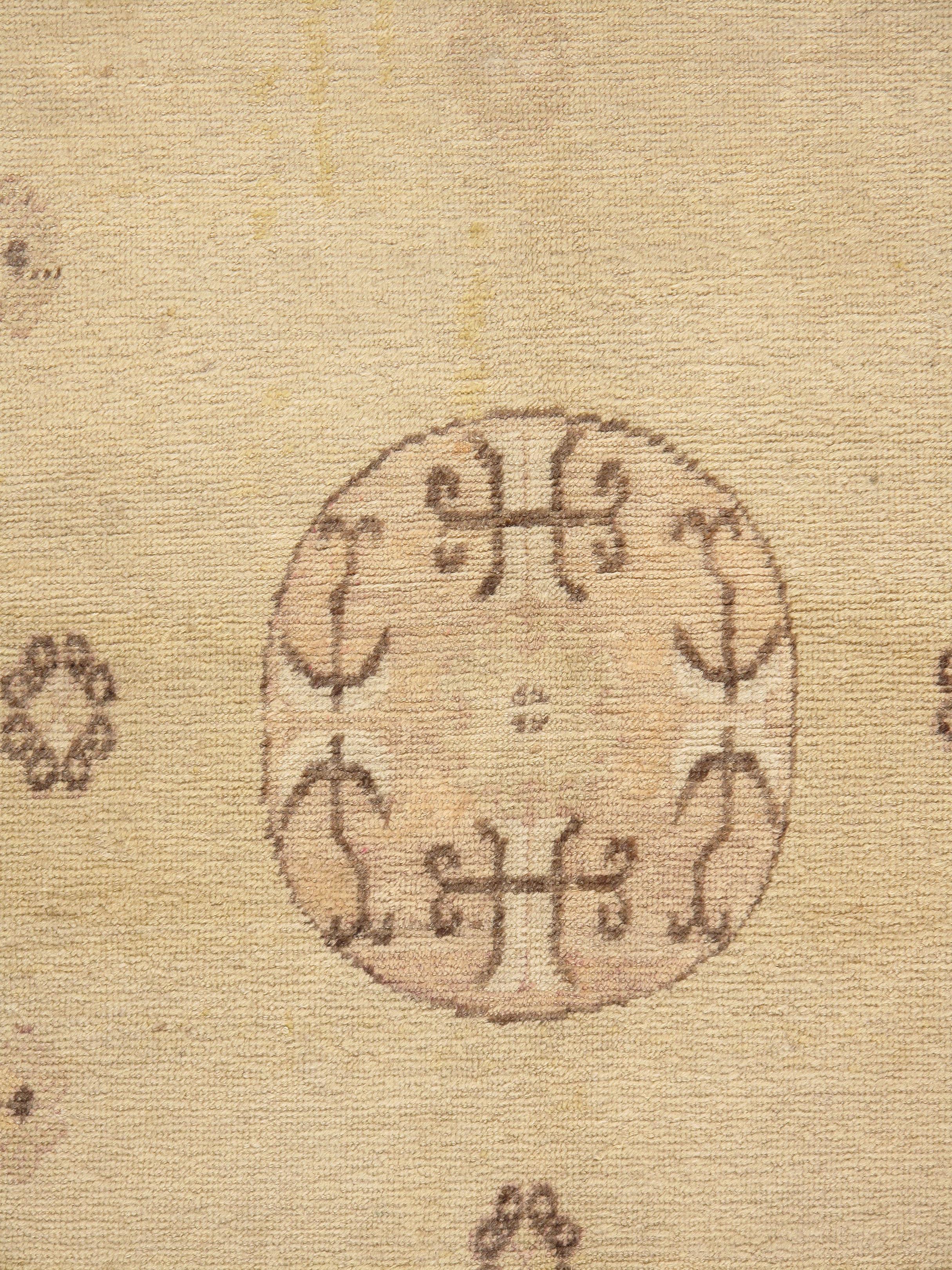 Antique Khotan Samarkand Rug 4'6 x 6'6. This antique Khotan from China is a geometrically designed beauty. Woven in cream dark chocolate and rose this rug displays its elegance in the restrained circular designs in the central field. Strong diagonal