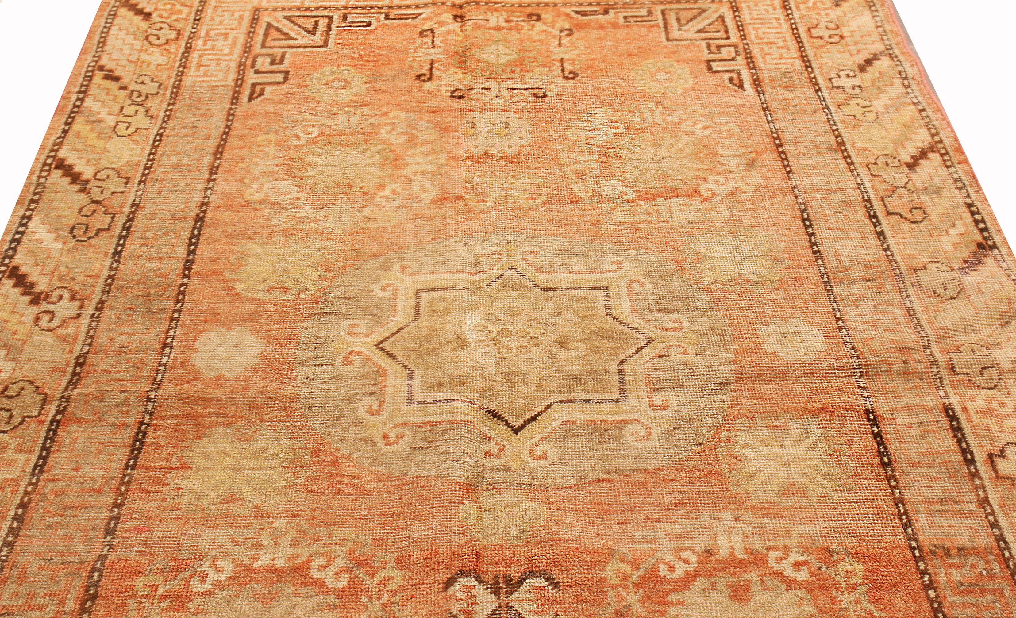 Originating from East Turkestan between 1900-1920, this antique transitional Khotan rug has a lesser known, once-acclaimed field design. Handwoven in durable, high quality wool, the central medallion depicts an ornate eight-pointed star, a