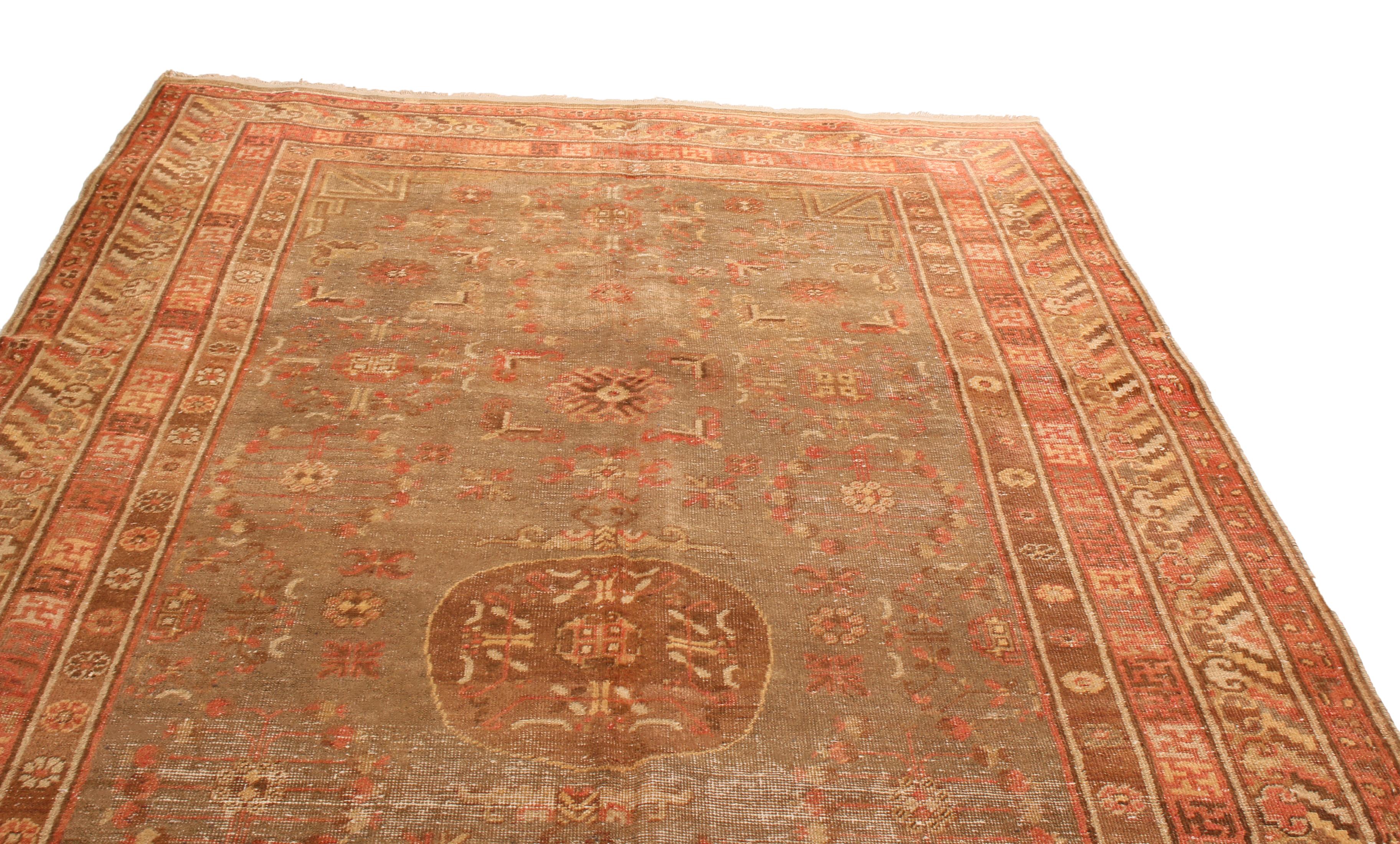 Hand knotted in quality wool, this Khotan runner originates from Turkestan circa 1920-1930. The gracious scale presents itself in a scintillating dark blue-gray backdrop that beautifully complements the rich brown hued medallion. Colors of red,