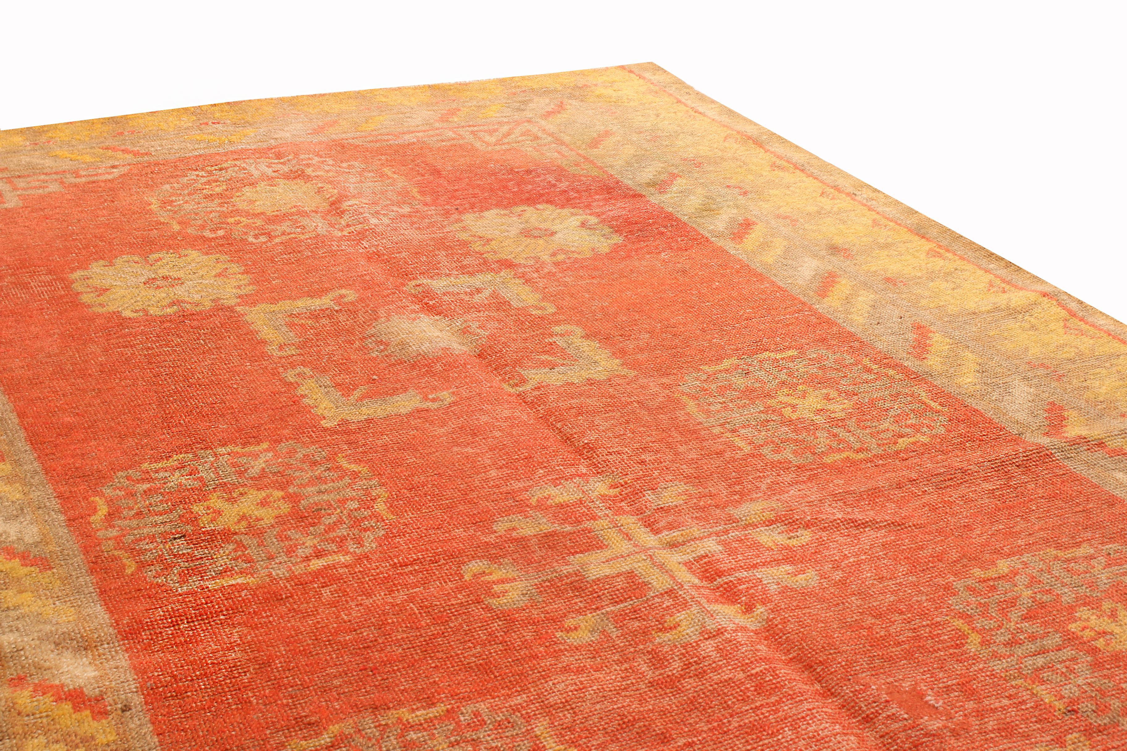 Originating from East Turkestan between 1920-1940, this semi-antique transitional Khotan rug from Rug & Kilim is entering its first year as an antique in good condition. Handmade in quality wool, the field design depicts an individualistic series of