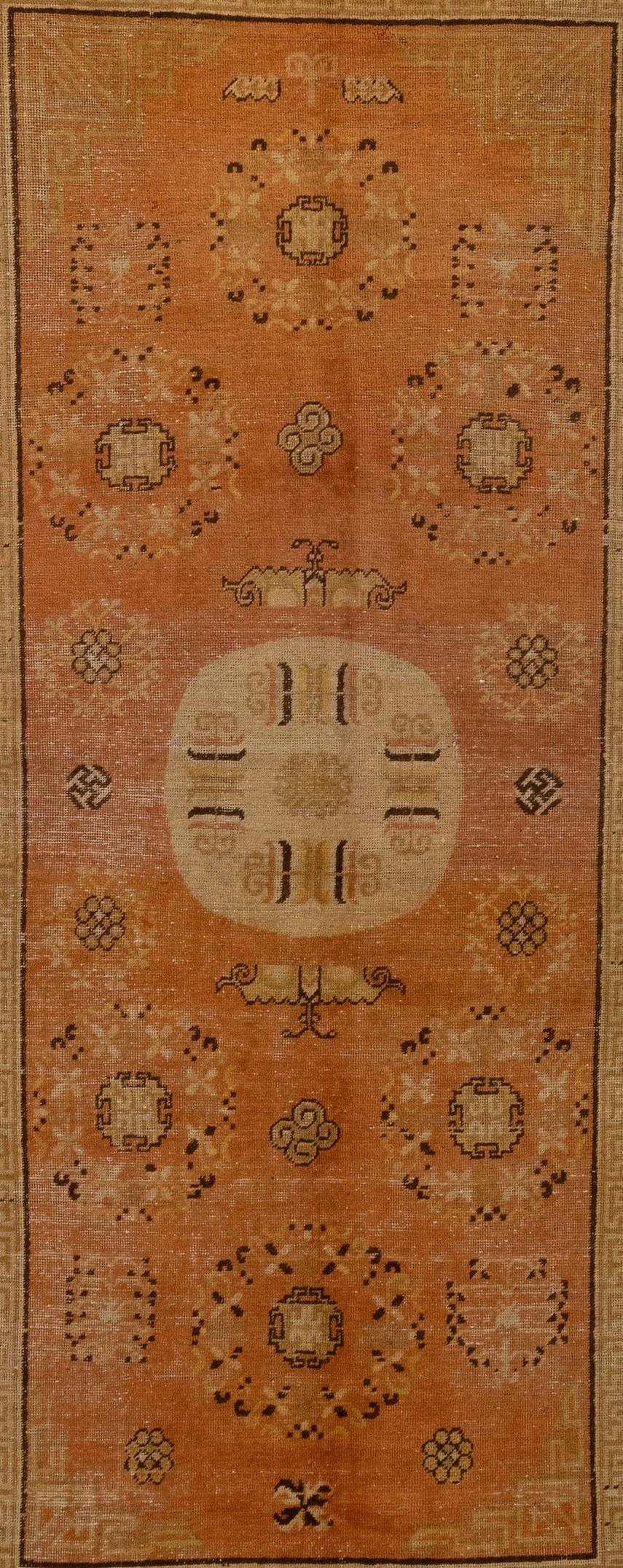 This antique Khotan rug from East Turkistan is truly stunning. It's clear that a lot of care and attention went into its creation around 1900, and the circular medallion is the real highlight. I love how each one features a unique design and