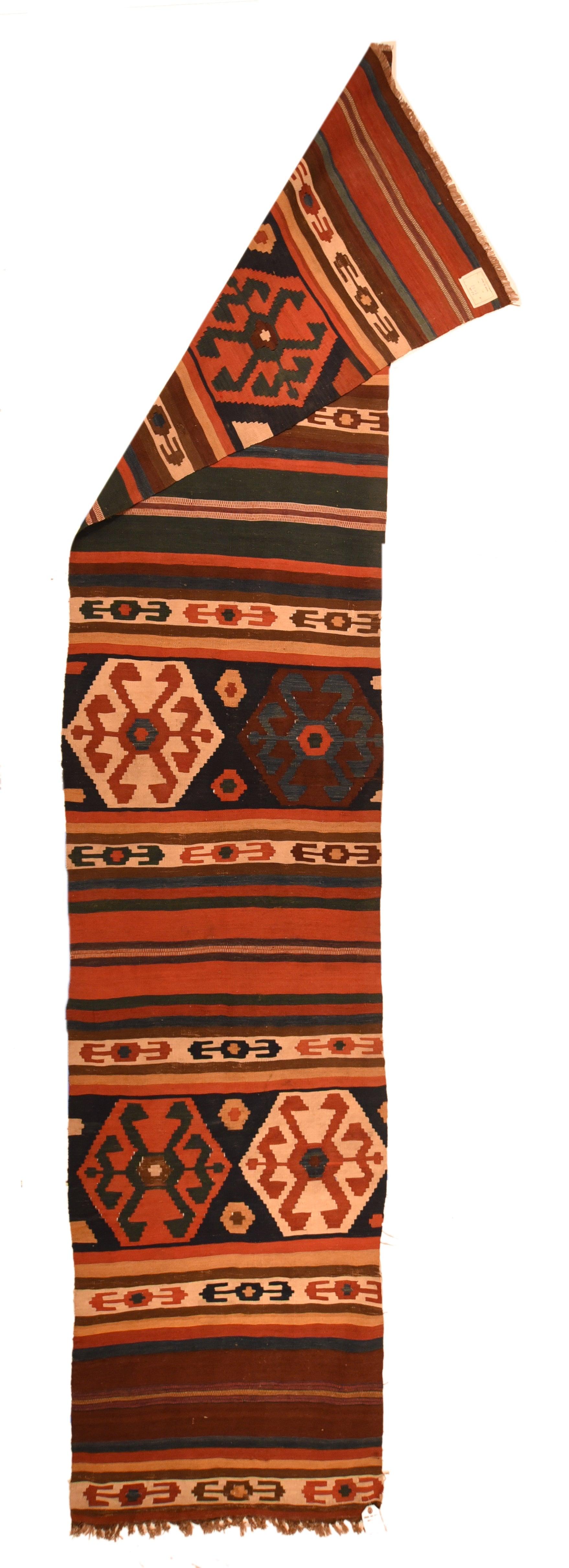 Antique Kilim Rug 2'8'' x 12'6''. In a semi-Caucasian style, but bolder, with three wide panels each showing closely stepped hexagons in sandy stra, royal blue and rose. Narrower stripes of chocolate, red, navy, straw-camel and cream are evenly set