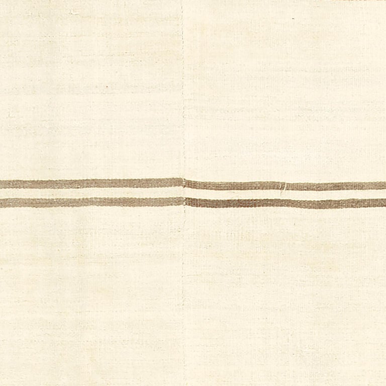 Handwoven Kilim rug circa 1940 Turkey

3 Soft beige panels with a set of 7 stripe pairs in bronze.
