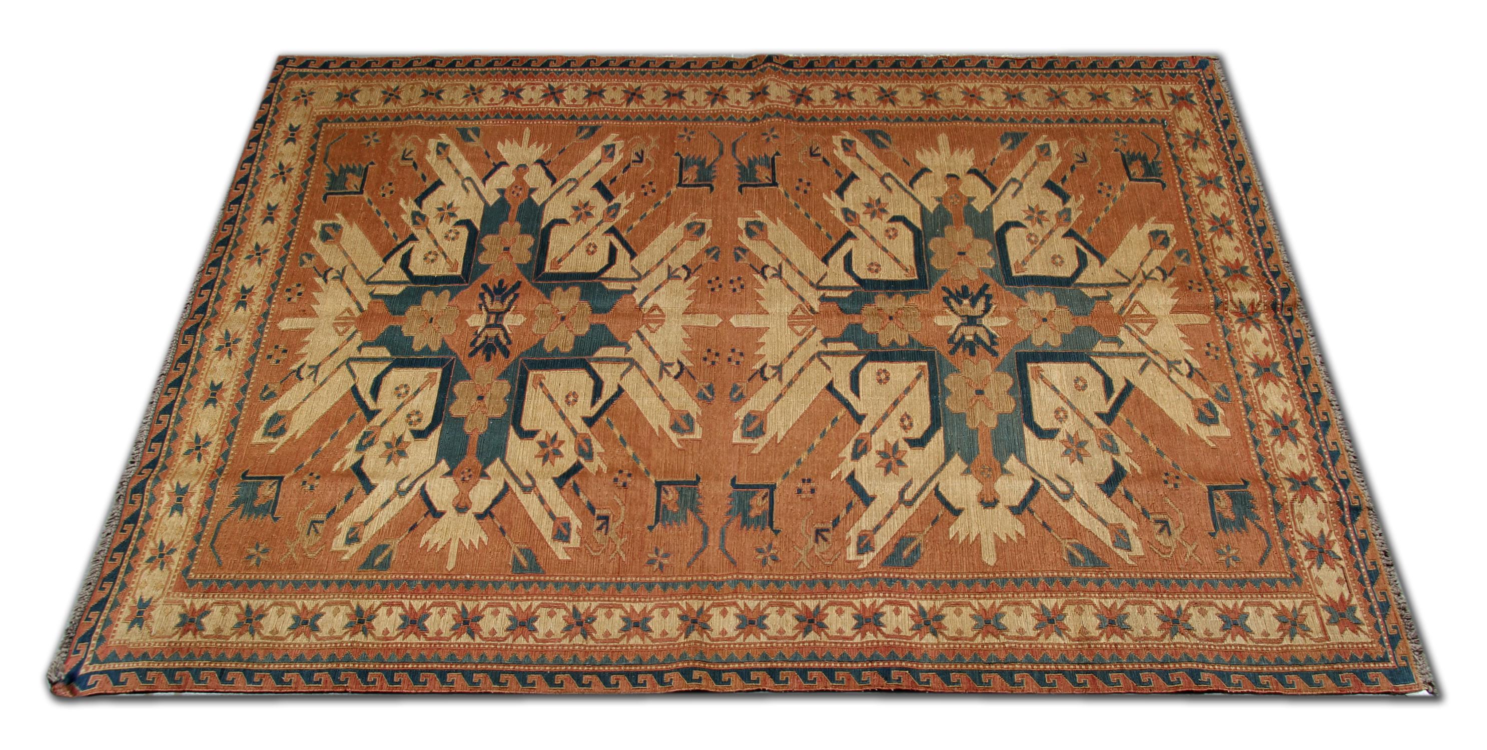 This handwoven wool Sumak rug was constructed in Caucasia in the early 20th century. Featuring a fantastic double medallion design woven in cream, rust and blue on a rusty cream background. Woven with a great level of detail, with medallions and