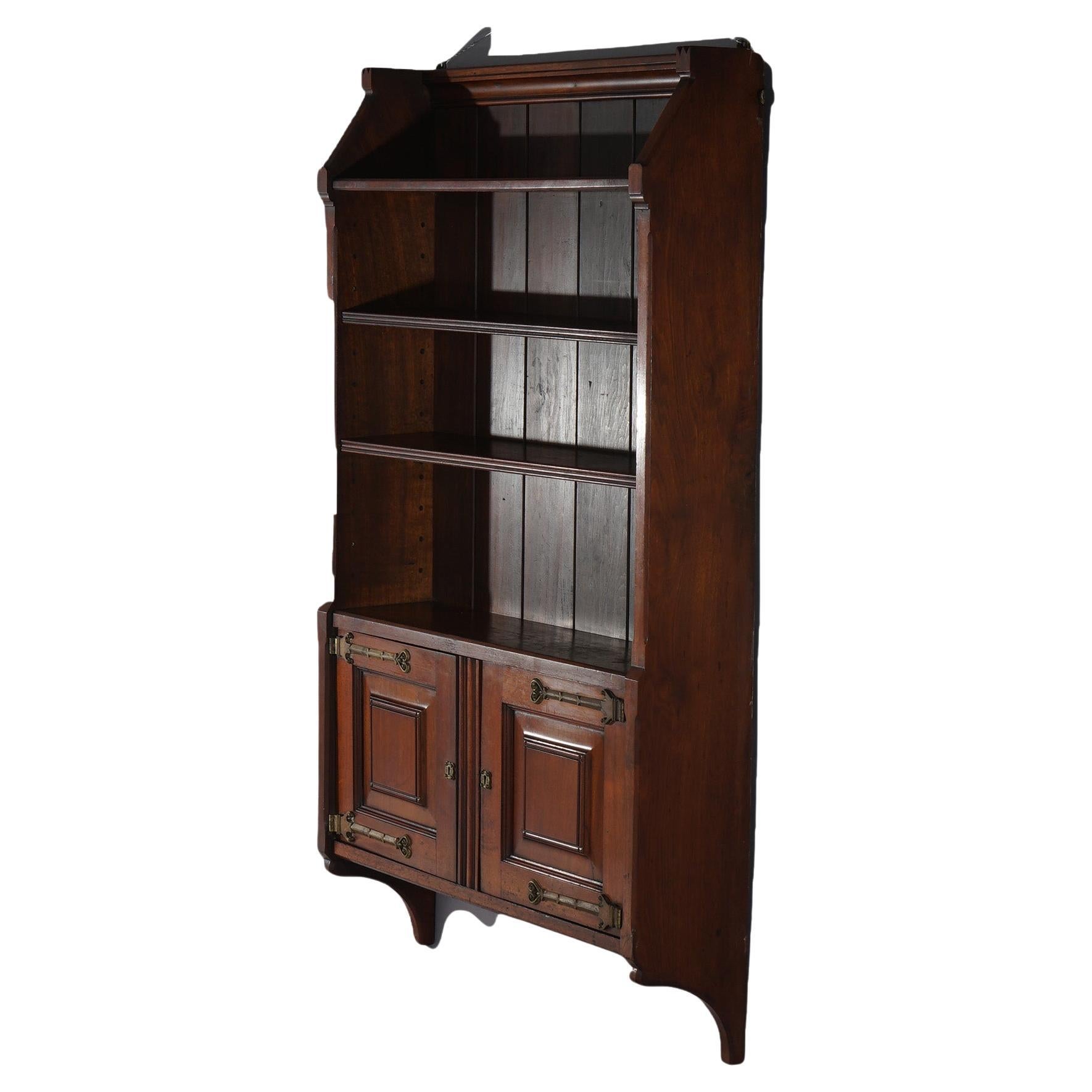 An antique Aesthetic wall shelf in the manner of Kimble & Cabus offers walnut construction with double door cabinet below shelves, c1890

Measures - 56.5