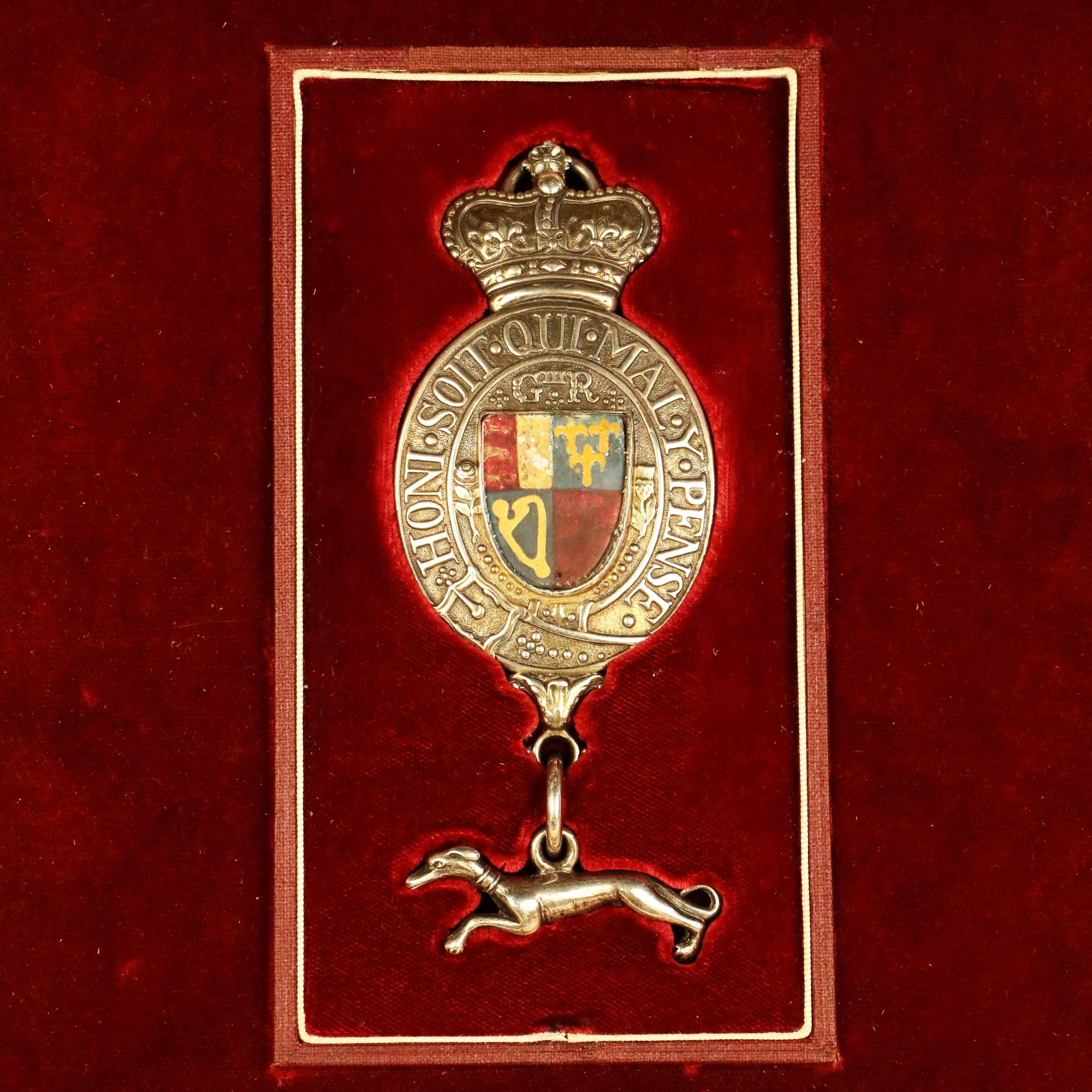 Antique King's silver messenger badge, of typical form, the heraldic shield quartered and set within the order of the Garter, with crown above G111R (for George III) and with a fleeting greyhound suspended, emblematic of swiftness.

These badges