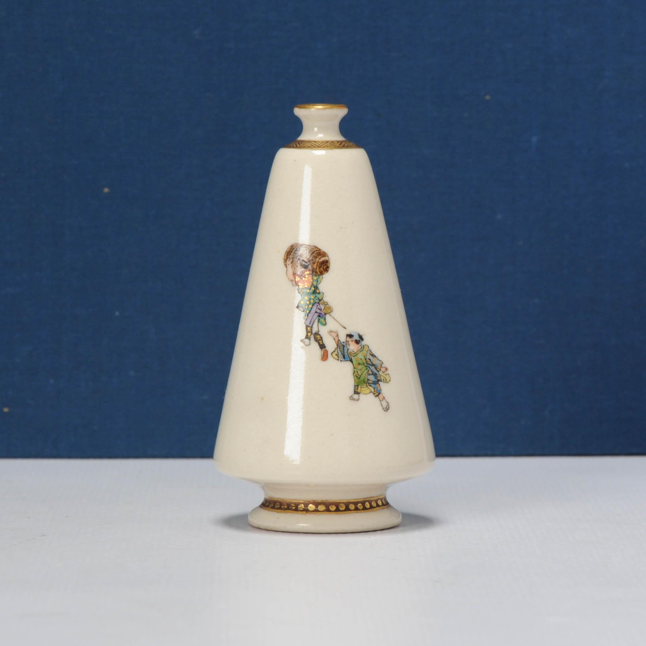Meiji era (1868-1912), late 19th/early 20th century. Decorated in enamels and gilt, comprising a conical vase depicting a two men carrying rice bales, a third man giving chestnuts to a child, another child balancing a tea set on his head, signed in