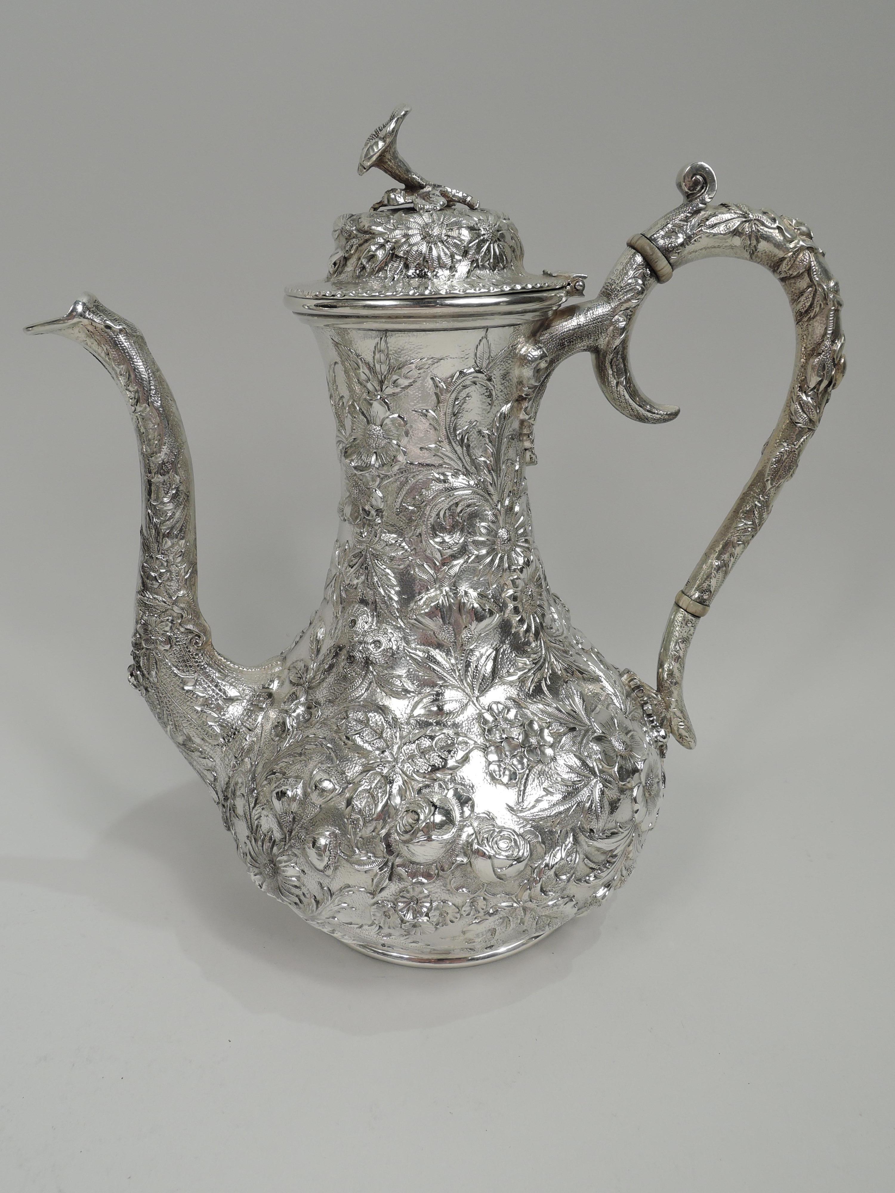 Edwardian repousse sterling silver coffee and tea set. Made by S. Kirk & Son Inc. in Baltimore. This set comprises 5 pieces: Coffeepot, teapot, creamer, sugar, and waste bowl. Each: Bellied bowl on stepped foot. Handles high-looping and leaf-capped,