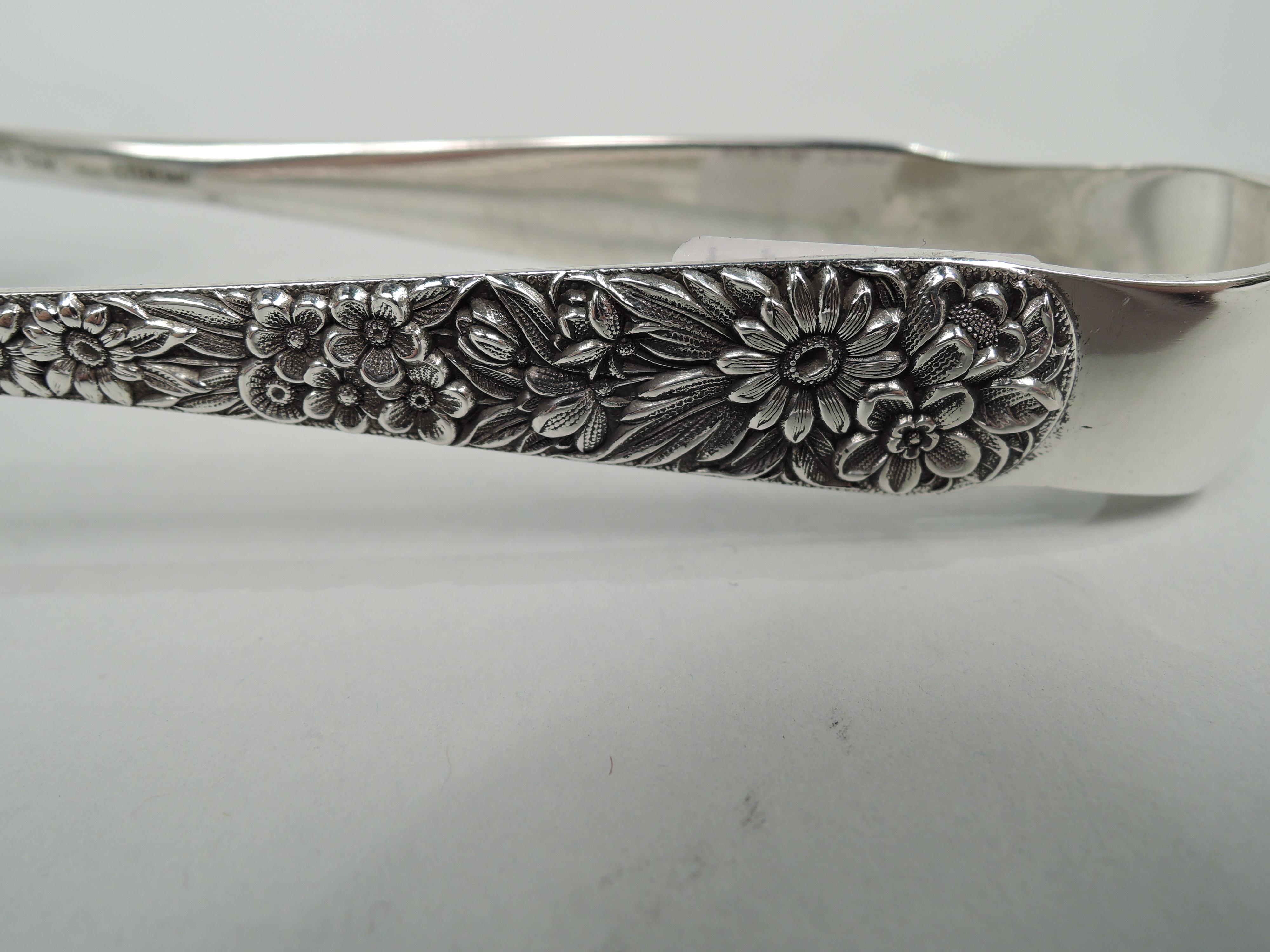 Repousse sterling silver ice tongs. Made by S. Kirk & Son in Baltimore, ca 1890. U-form with leaf jaws and floral repousse applied to stems. Marked “S. Kirk & Son Sterling”. Weight: 2 troy ounces.