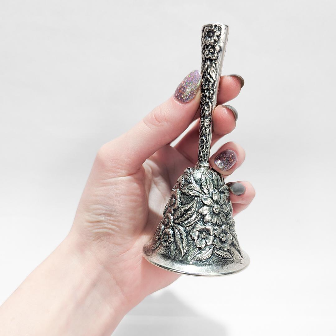 A fine silver table bell.

By S. Kirk & Sons, Inc. of Baltimore.

In sterling silver.

With repoussé decoration throughout.

Engraved to the top of the handle with a monogram.

Fully hallmarked to the interior rim.

Simply a wonderful antique