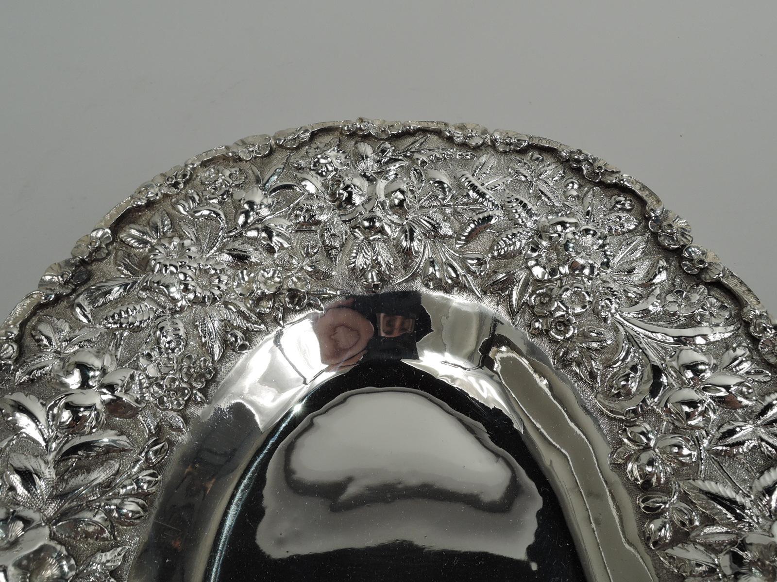 Victorian sterling silver bowl, ca 1890. Made by S. Kirk & Son in Baltimore. Plain oval well and wide shoulder with repousse ferns and flowers on stippled ground. Rim has applied c-scrolls and flower heads. A pretty piece in the historic regional
