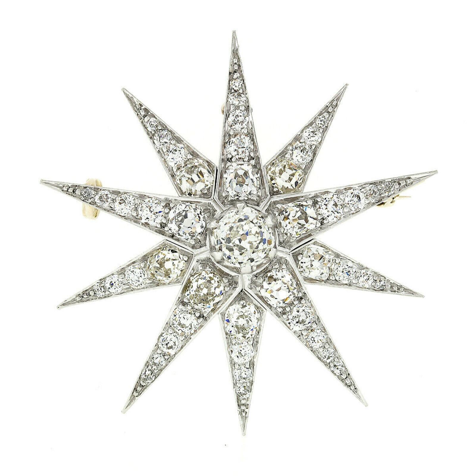 This stunning, fancy antique brooch/pendant was crafted from solid 14k yellow gold during the Edwardian era. The center of the snowflake design features a gorgeous and truly characteristic GIA certified, old mine cut diamond multi-prong set at its