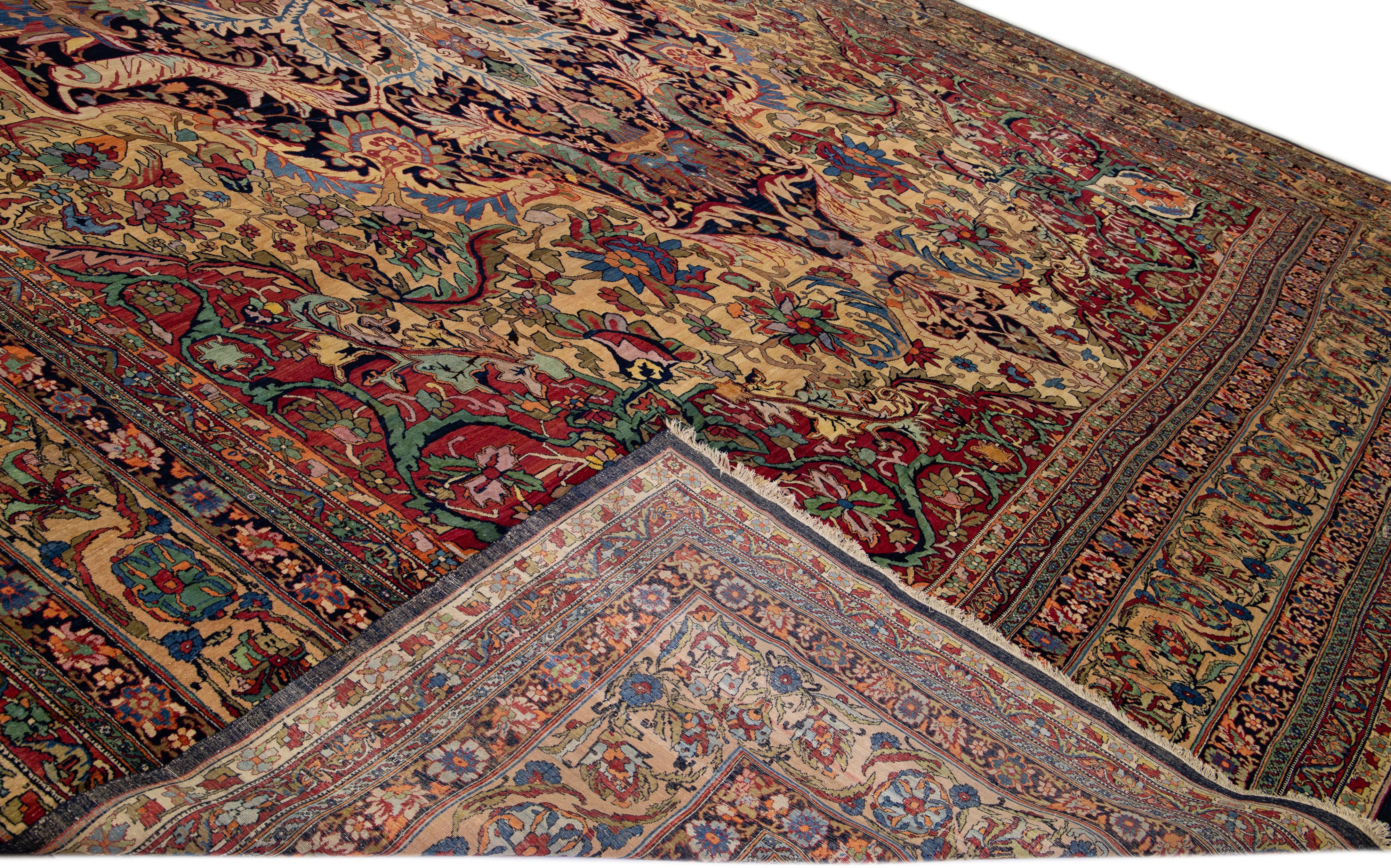 An extraordinary Beautiful antique Kirman hand-knotted wool rug with a beige and red field. This Persian rug has multicolor accents in a gorgeous medallion floral pattern design.

This rug measures: 16'9