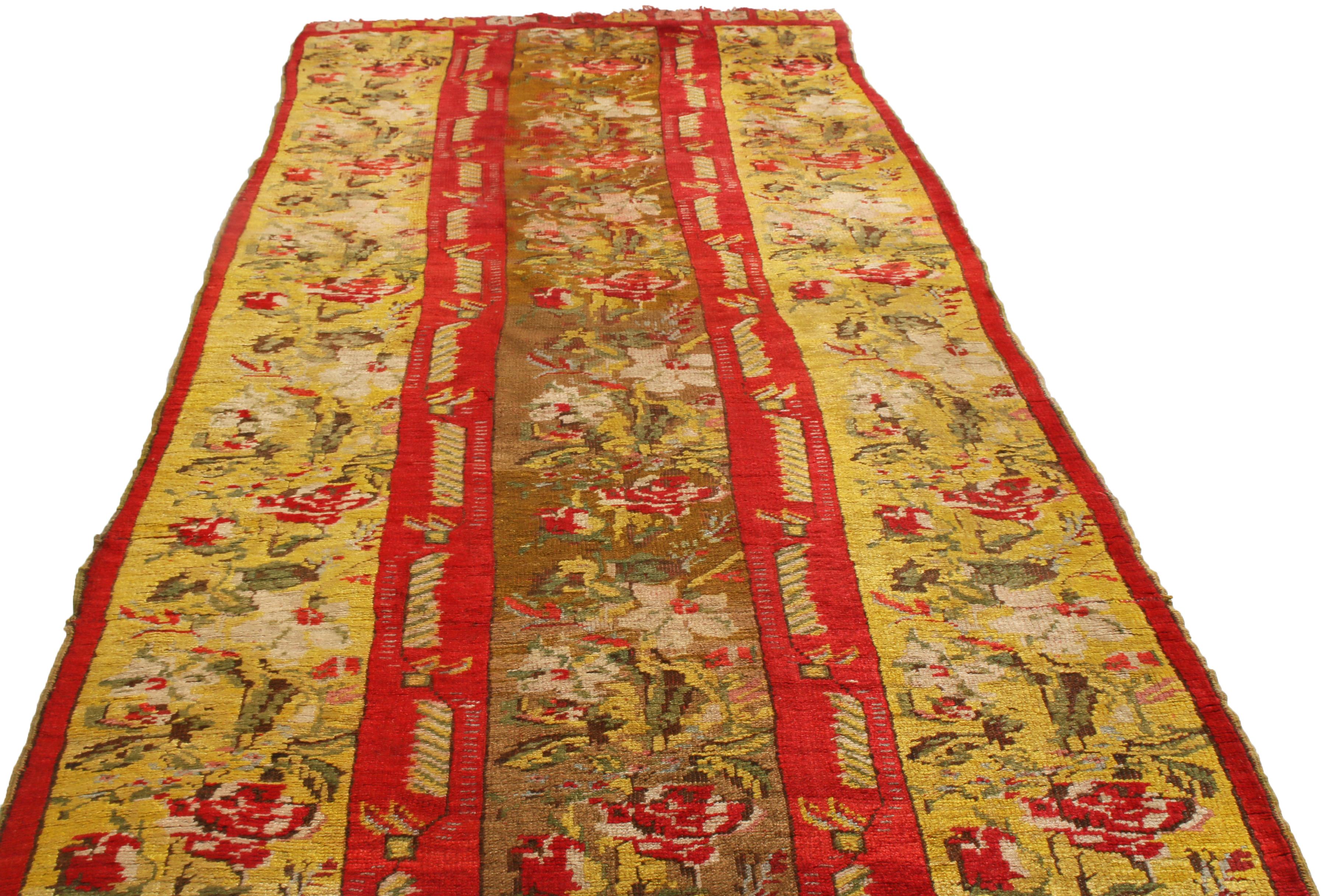 Originating from Turkey in 1910, this antique Kirsehir runner is hand-knotted in luminous, quality wool wile with a distinguished three-column field design among its kind. The all-over field design enjoys both rich and earthen red, golden-yellow,