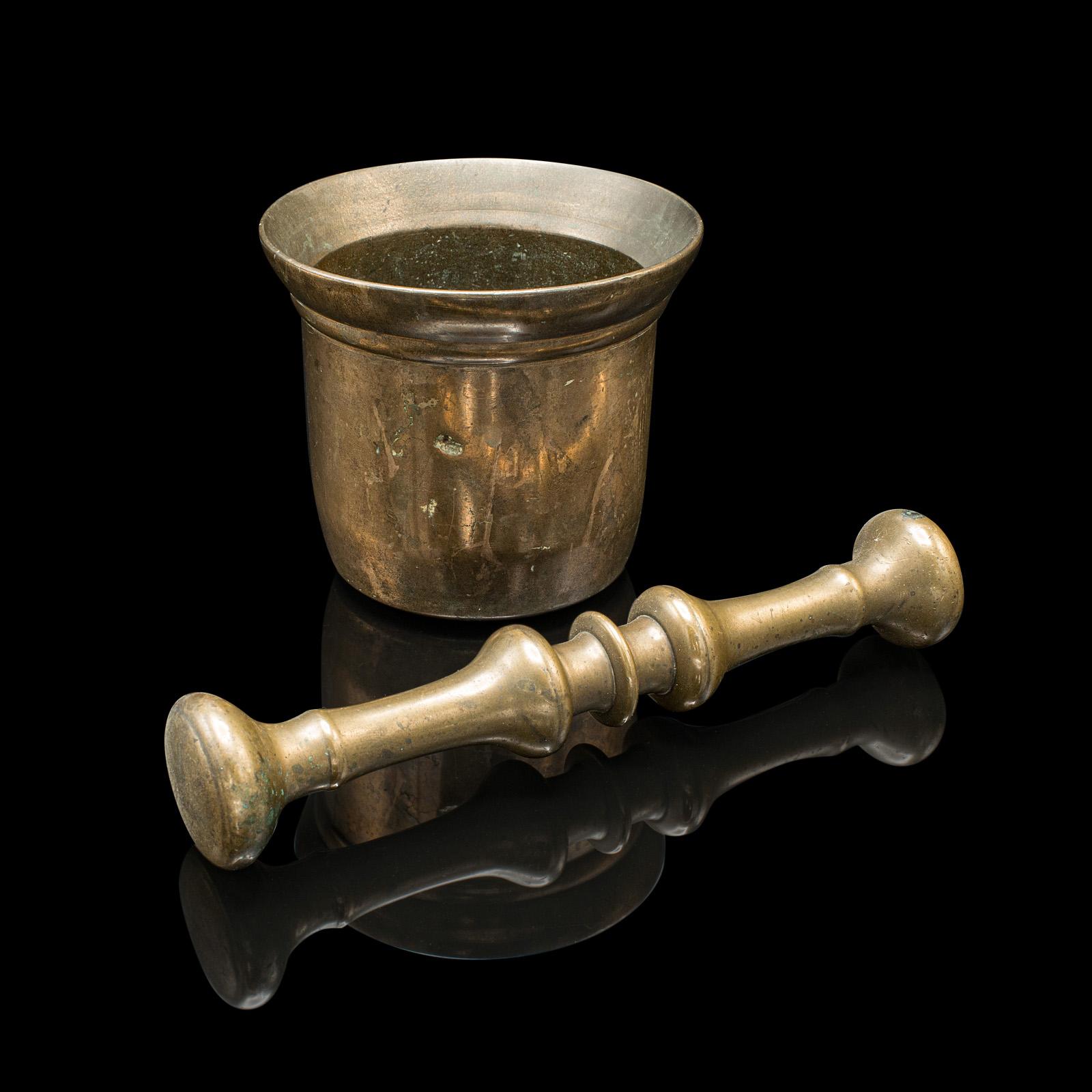 
This is an antique kitchen mortar and pestle. An English, bronze apothecary or chemist's shop aid, dating to the Georgian period, circa 1780.

Useful kitchen or apothecary aid from the Georgian period
Displays a desirable aged patina with lightly