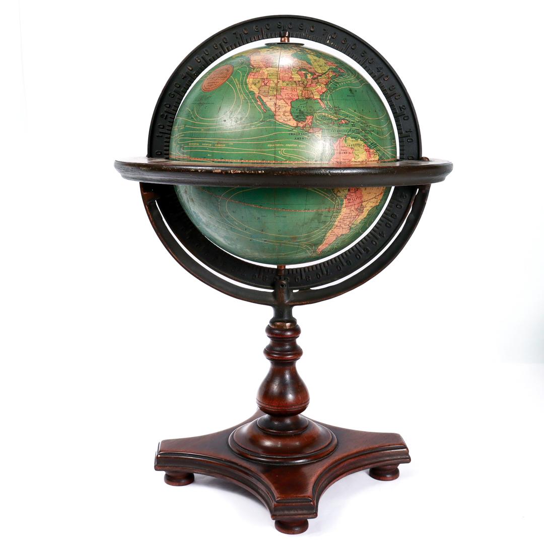 A fine, antique 8 inch terrestrial globe.

Manufactured by Kittinger Company, Inc. (in collaboration with the publishers W. & A.K. Johnston, Ltd. of Edinburgh, Scotland).

On a turned mahogany wooden base.

From the late 1920s or early