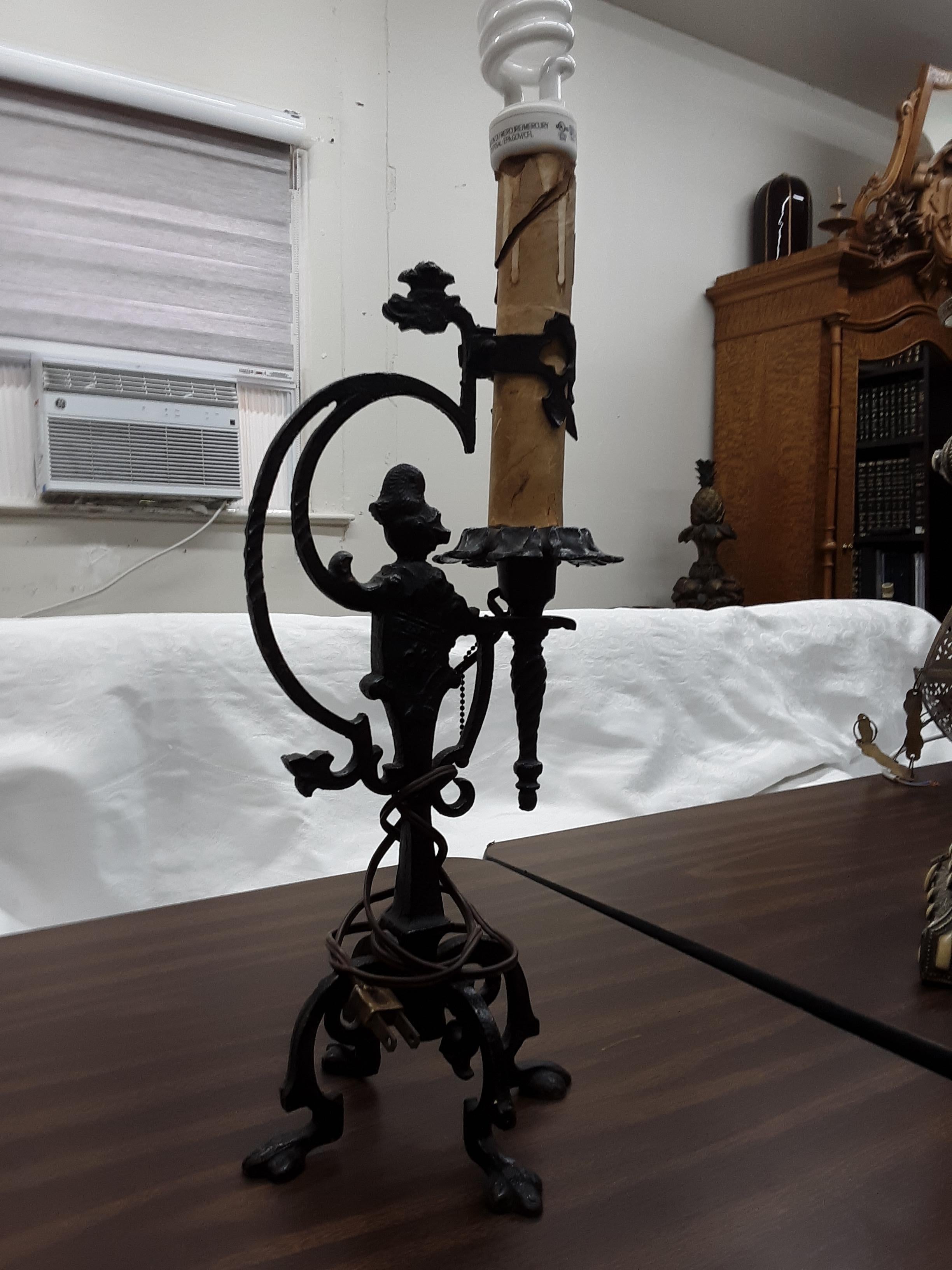 This is an antique wrought iron lamp of impeccable craftsmanship, the way it used to be made. This is a true collectors piece. No fake mass produced stuff. Great movie prop or deco item.