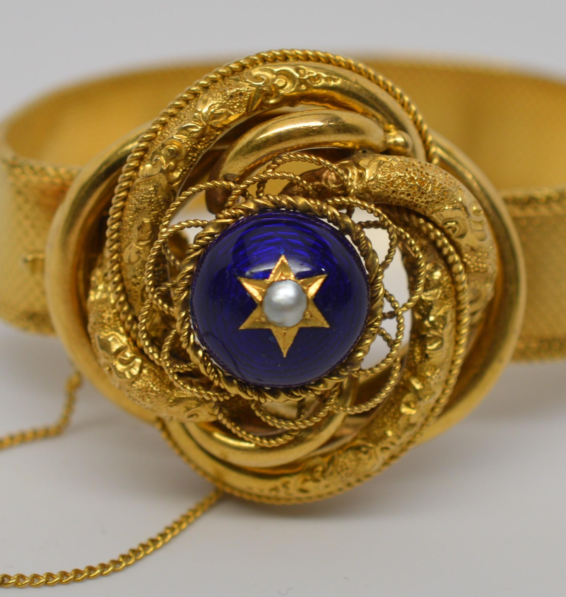 Stunning Antique Bracelet with an affix ornate knotted gold charm is crowned with a blue enamel decorated cabochon.  An elevated 1-1/2 inch knotted gold charm is intricately intertwined with textured patterned gold that give it brilliant dimension.