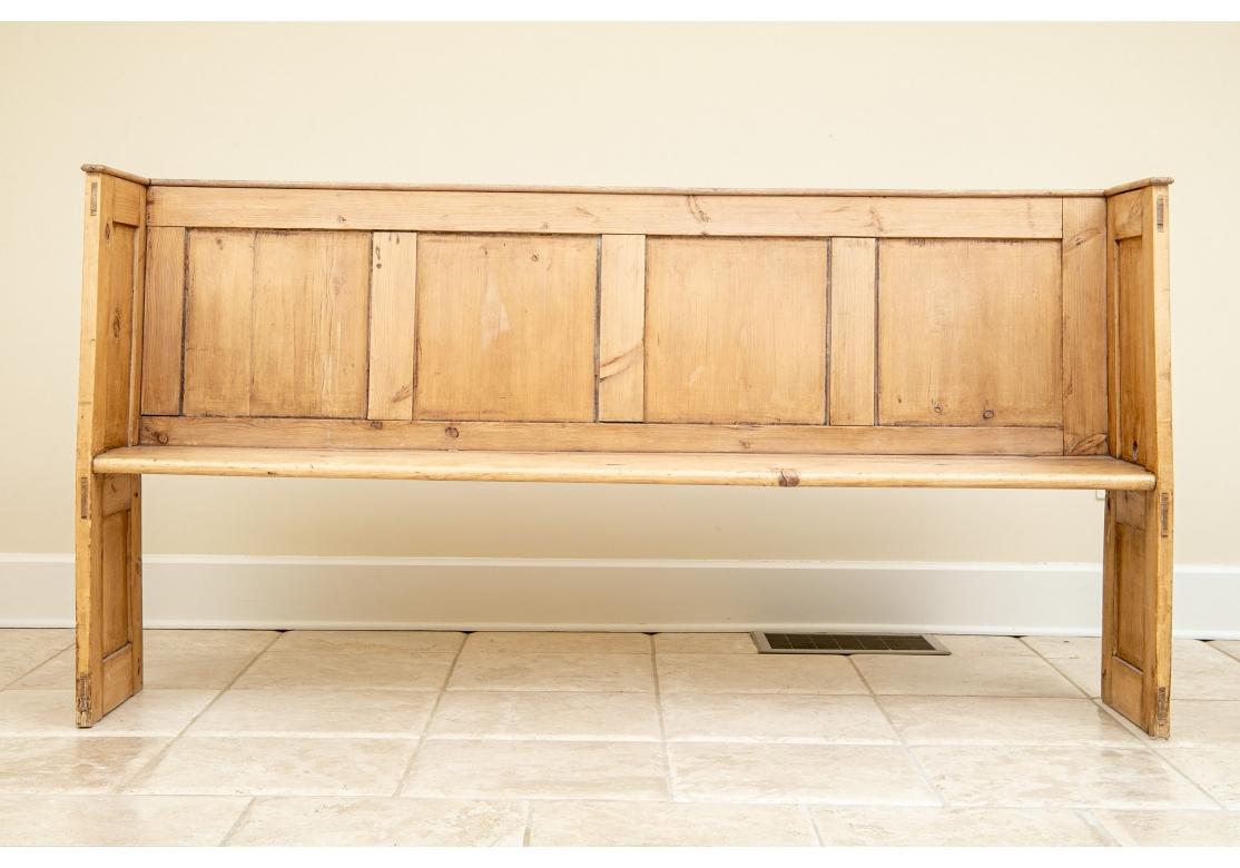 fine construction done in individual sections for the entire bench. There are separate panels on the tall back, tall sides and supports in the frames. The side panels have carved moldings. A hole appears on one side just above the seat. 
Measures :