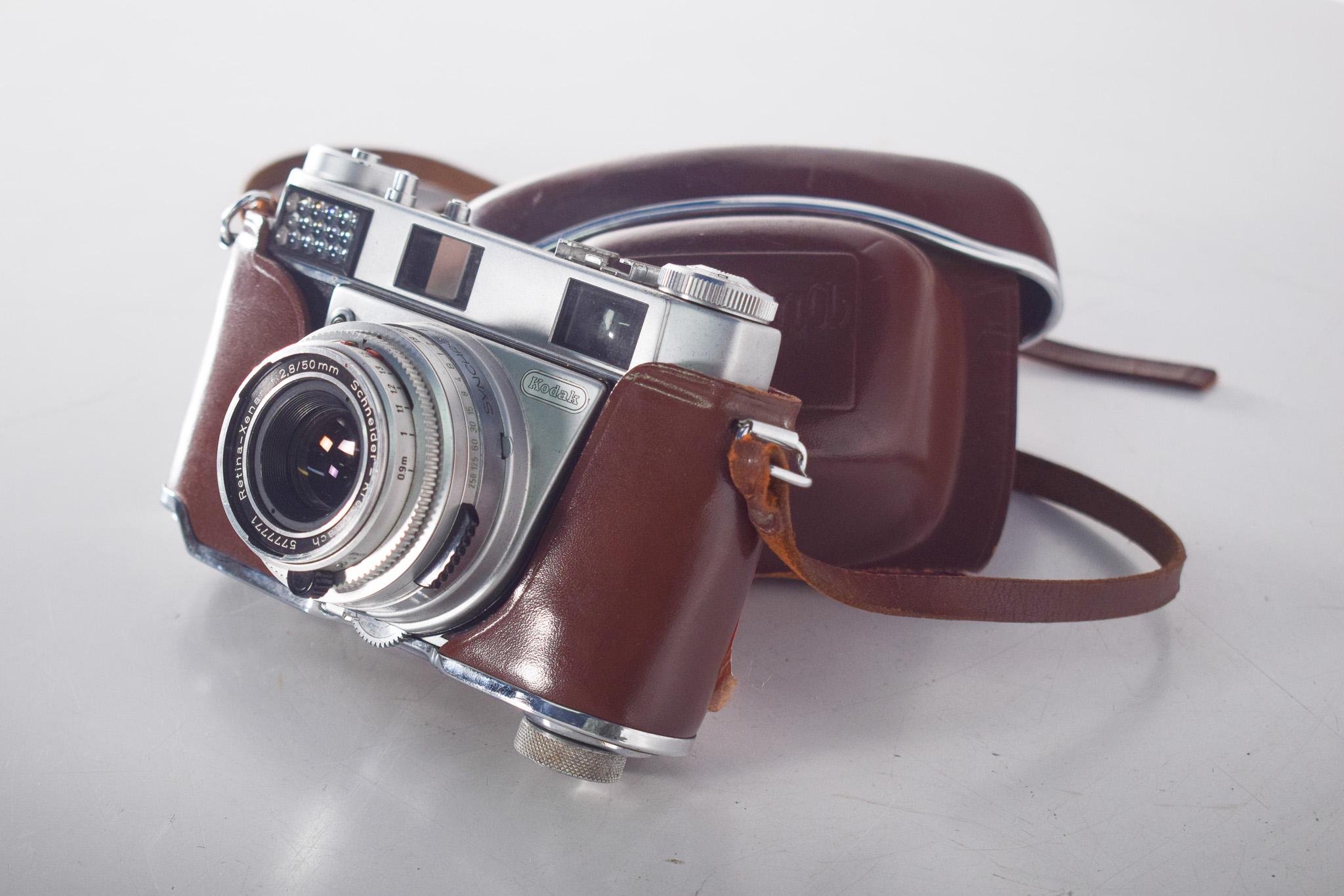 Kodak Retina III S Camera with Leather Case.  Analog is a Kodak Retina, equipped with a Schneider-Kreuznach Retina-Xenar 50mm f/2.8 lens, renowned for its sharpness and optical quality.
The metal frame and manual controls hark back to the precision