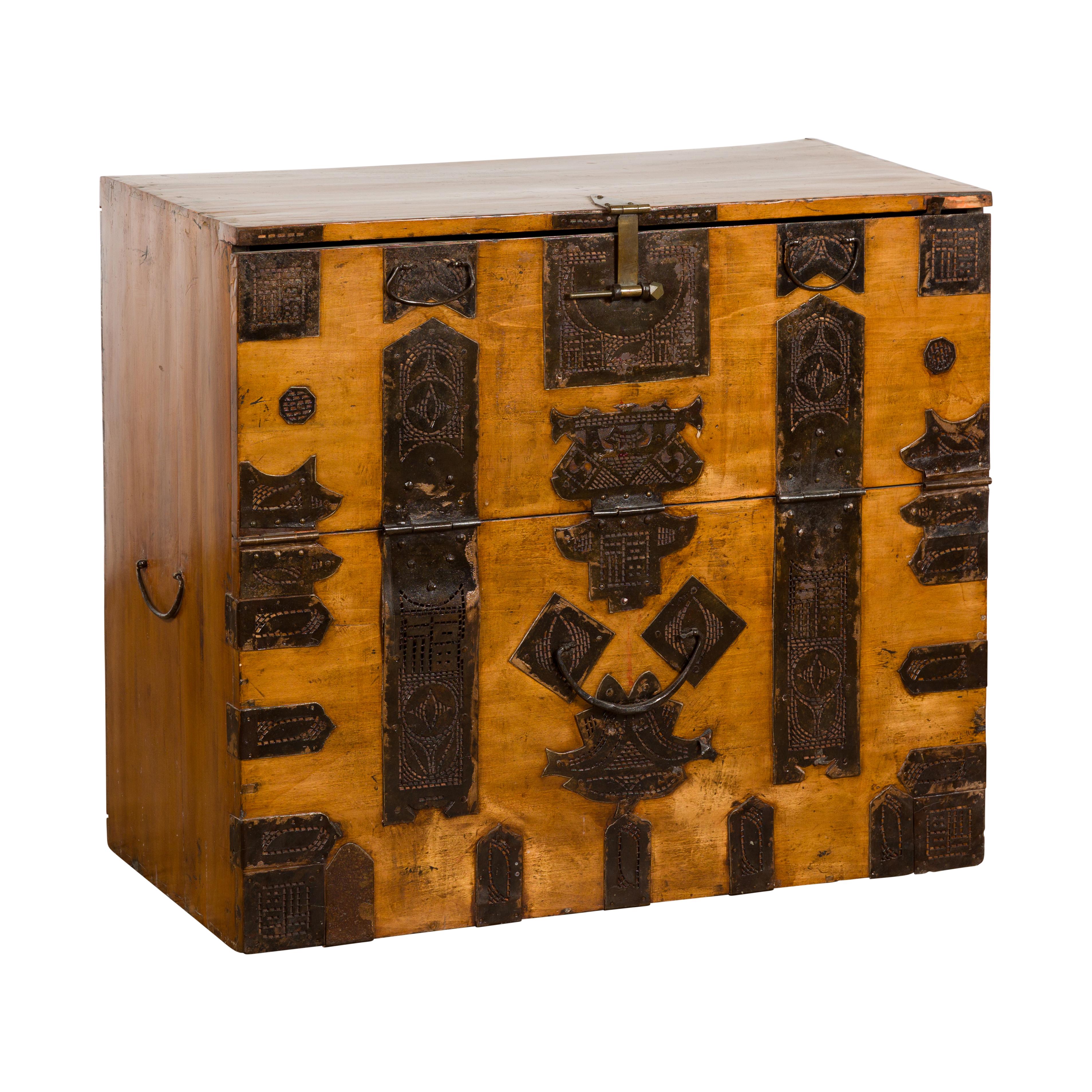 A Korean drop front blanket chest from the 19th century featuring decoration of stylized ornate hardware. Add a touch of traditional Korean charm to your space with this antique 19th-century Korean drop front blanket chest. Crafted from varnished