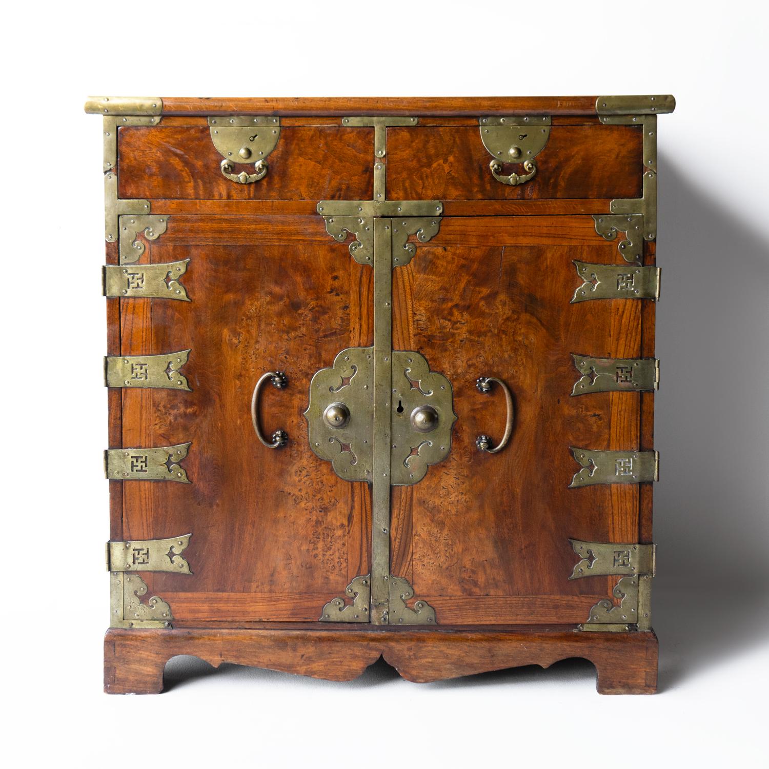 ANTIQUE KOREAN CABINET

A highly decorative piece of furniture made from elm and burr elm with decorative brass hardware and iron carrying handles.

Known as a KAP KAE SURI (갑게수리) which translates as a small container referred to as a “safe,” where