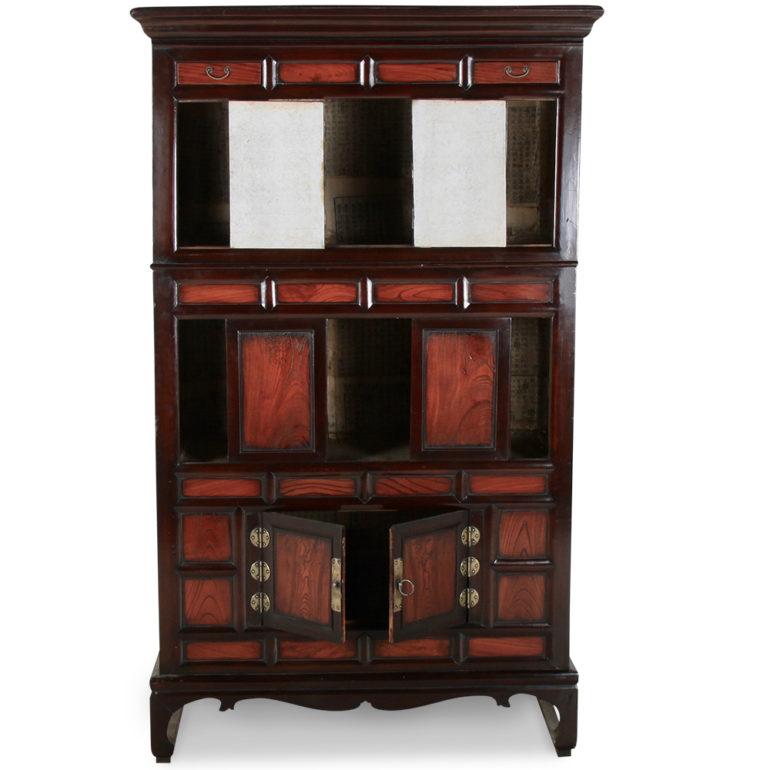 An antique Korean clothing cabinet from the late 19th century. This unique piece combines style with function: three separate covered shelves plus two decorative drawers at the top. The hardware is silver-colored and offsets the enamel and exotic
