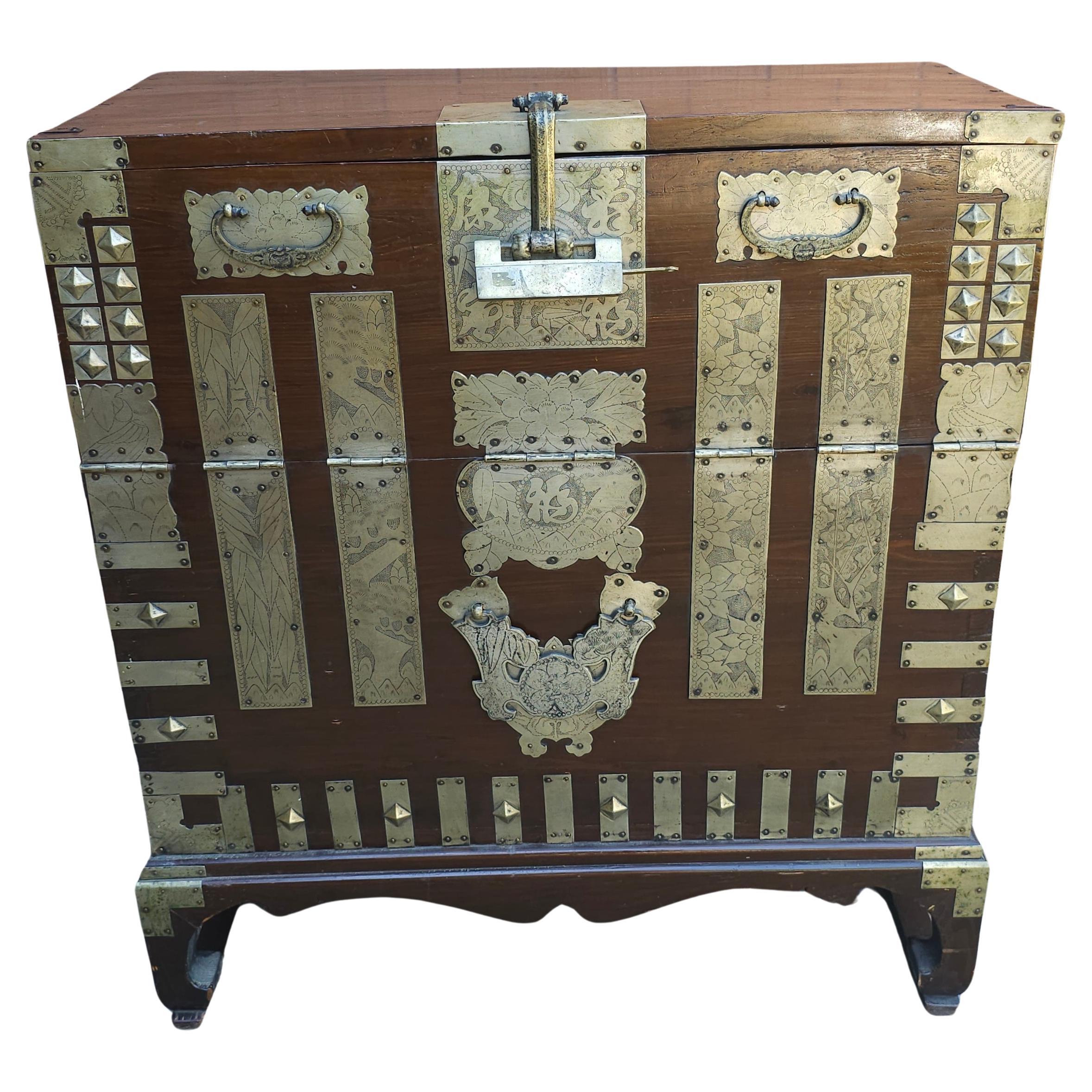 Antica cassapanca coreana per coperte, elaboratamente decorata con ornamenti in ottone in varie forme geometriche, alcune delle quali con paesaggi incisi e altre immagini come pini e bambù. La cassapanca ha anche una serratura a forma di farfalla.