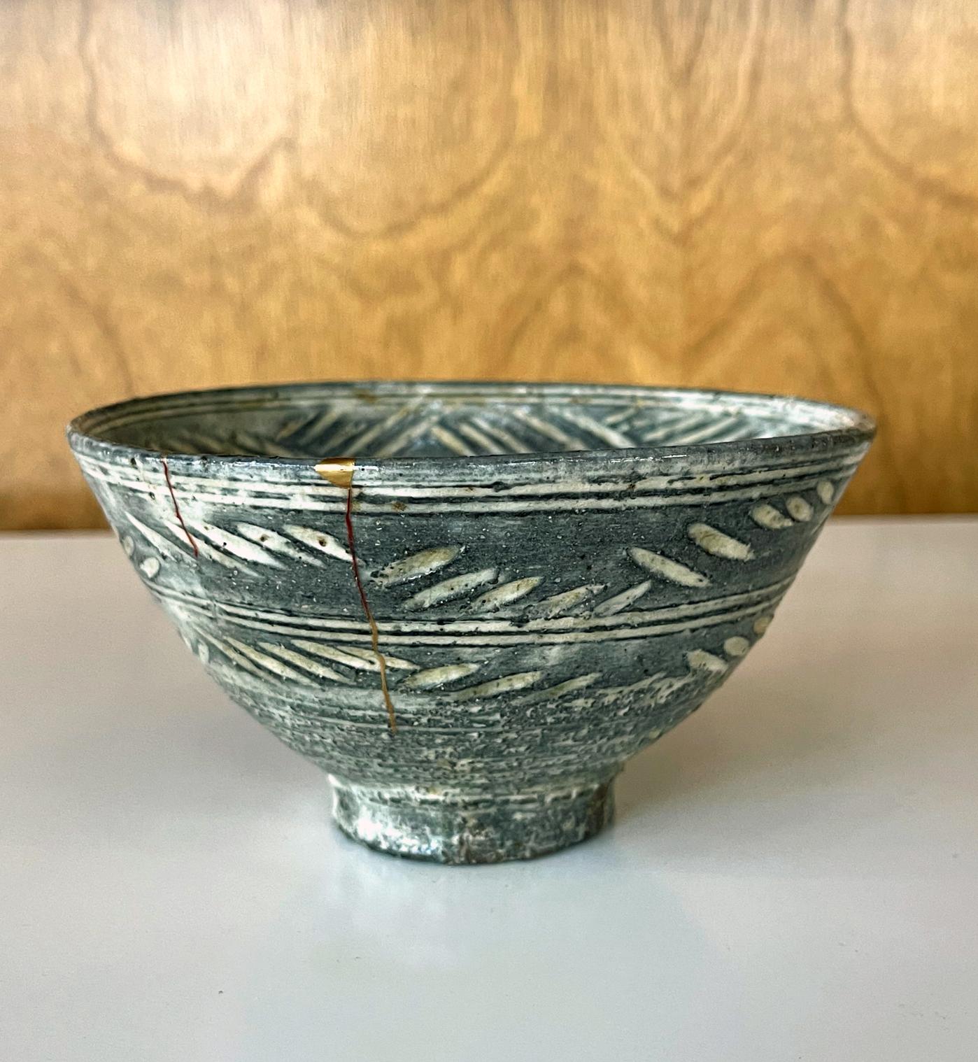 A Korean Hori-Mishima Chawan (tea bowl) circa 16th-17th century (Joseon Dynasty). The tea bowl is of an upright conical form supported by a high foot ring. It was decorated with incised brushwood fence patterns filled with white slip on both the