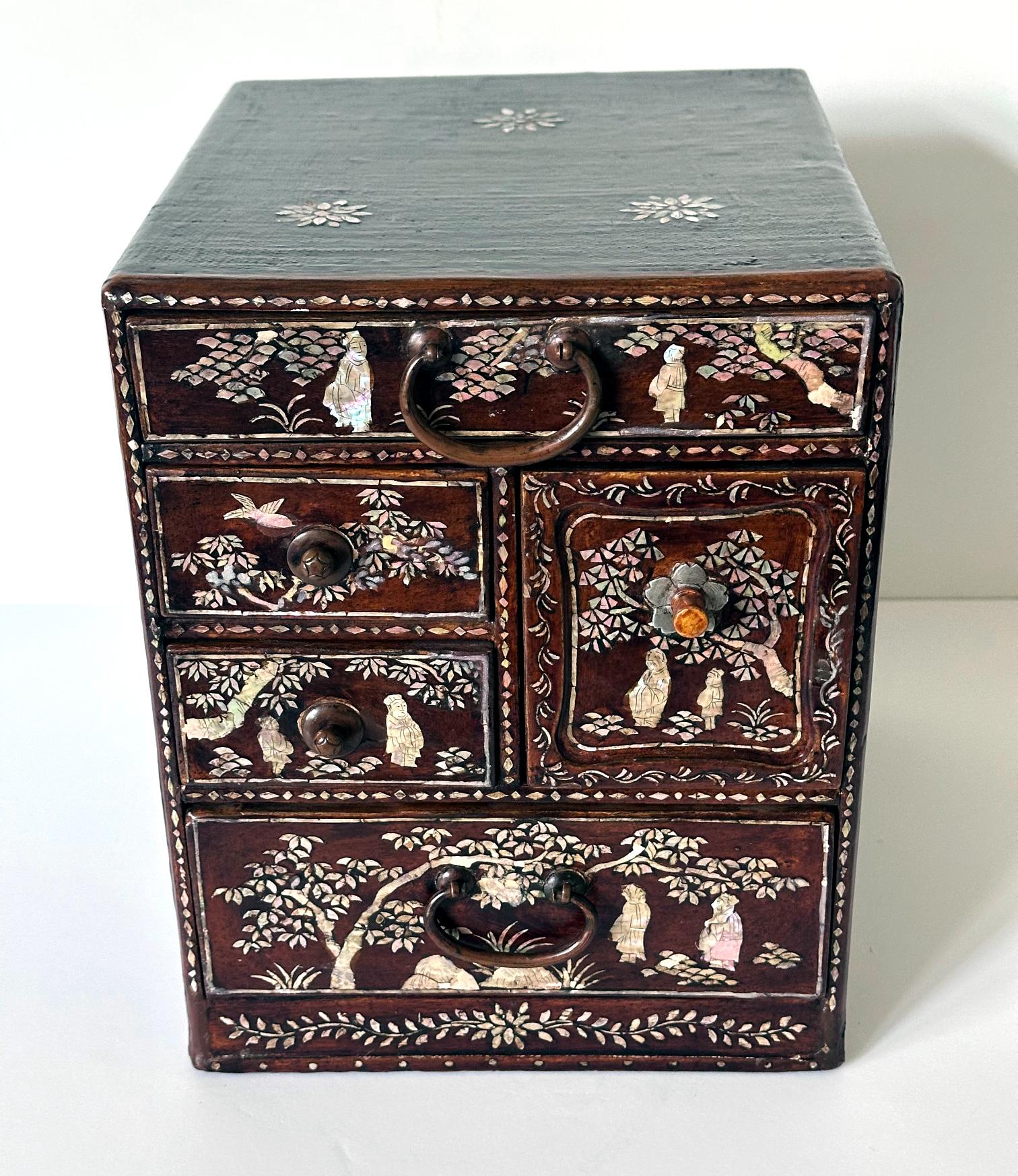 An antique Korean lacquered small chest of drawers with Mother-of-Pearl inlays circa 19th century (late Joseon Dynasty). The tabletop box with multiple small drawers of various sizes was traditionally used to store hair and makeup accessories such