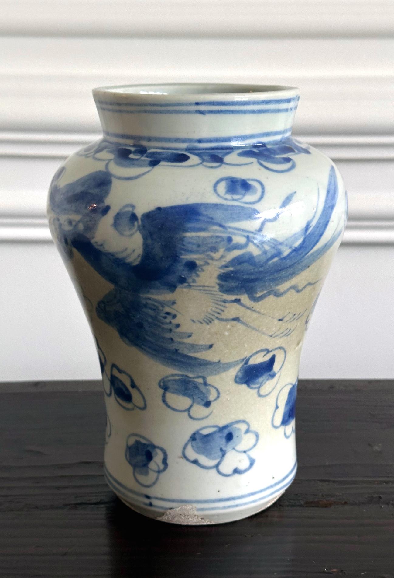 A korean white porcelain jar with underglaze blue paint circa late 19th century toward the end of Joseon Dynasty. Porcelain jars of this elongated form with swell shoulder, wide mouth through a short, everted neck were made in various size in the