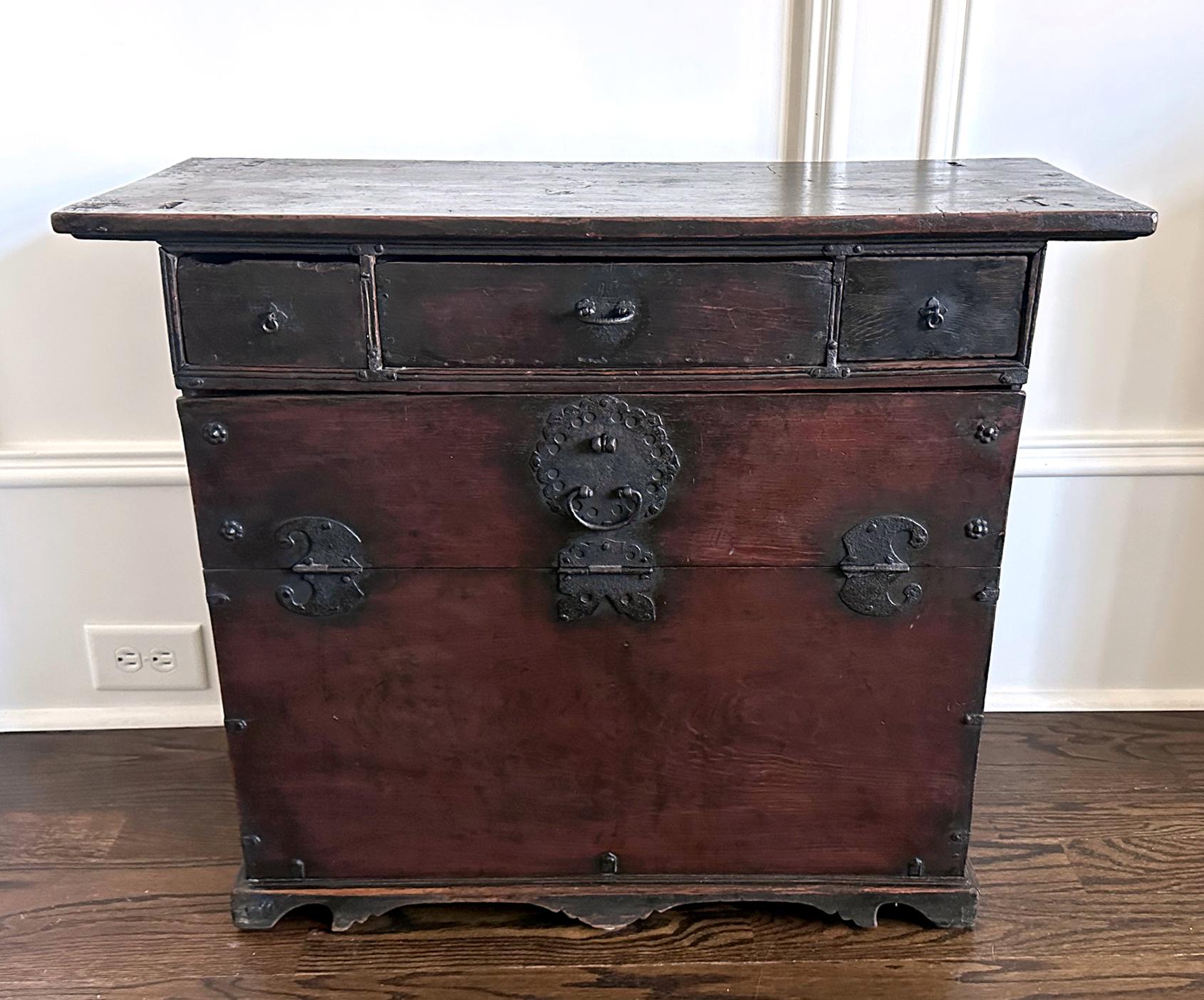 A small Korean drop-front chest (Bandaji) made from zelkova wood (Korean Elm) with iron hardware fittings circa early to mid-19th century (Joseon period). Possibly from Chungcheong Do, located in the central west of Korean peninsula, this Bandaji of