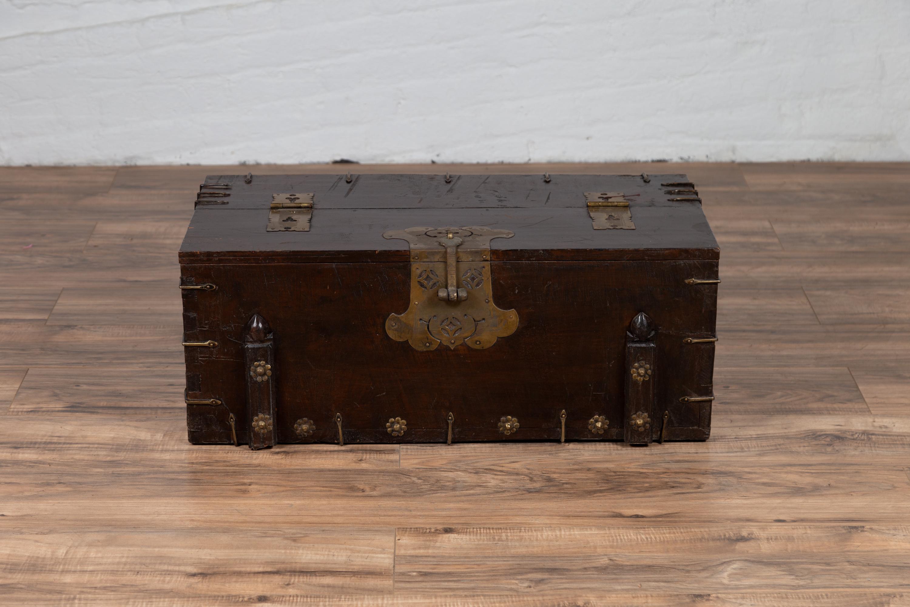 An antique Korean wooden chest from the early 20th century, with cut brass hardware and folding top. Born in Korea during the early years of the 20th century, this small wooden chest features a linear silhouette, perfectly accented with cut brass